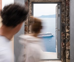 a man and a woman looking at a painting on a wall