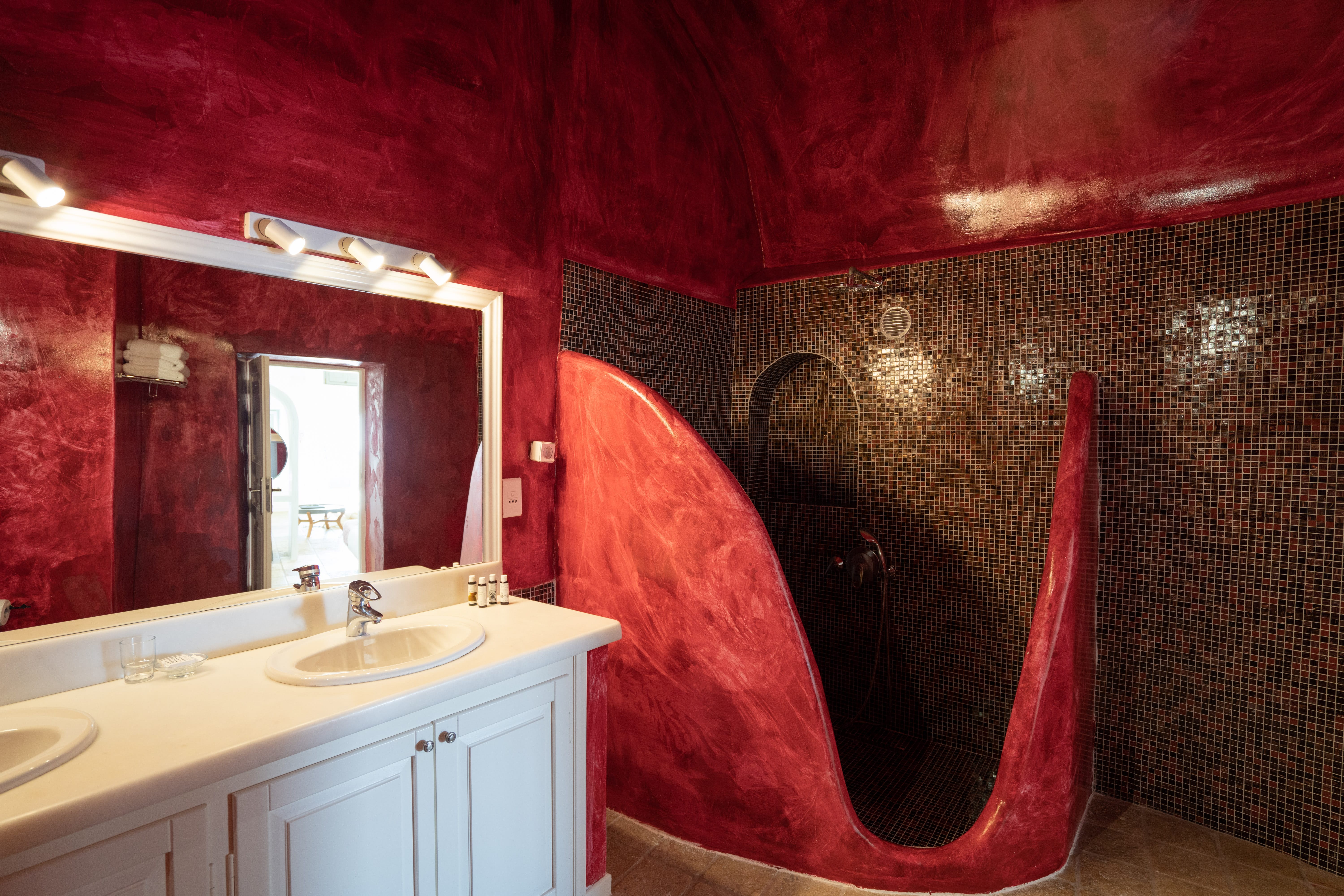a bathroom with a red shower curtain