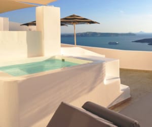 a pool and chairs on a deck