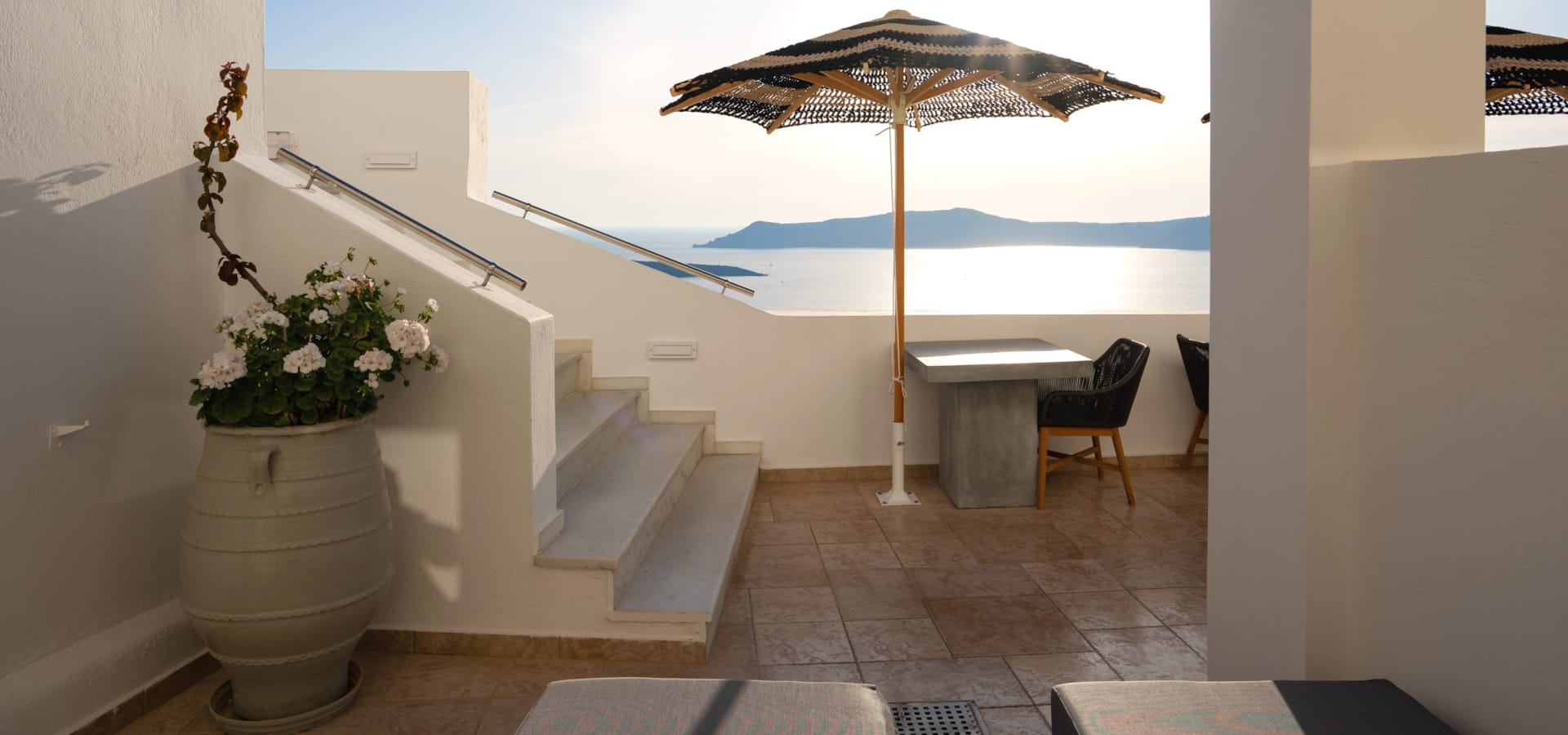 a patio with a table and chairs and an umbrella
