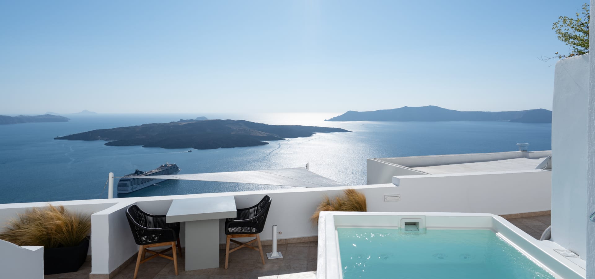 a pool and a table by a large body of water