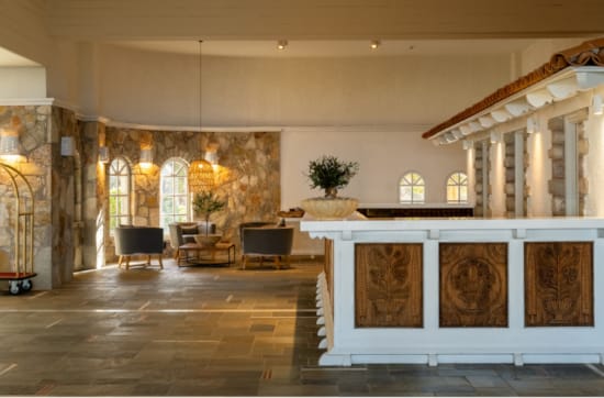 a large room with a large marble counter and chairs