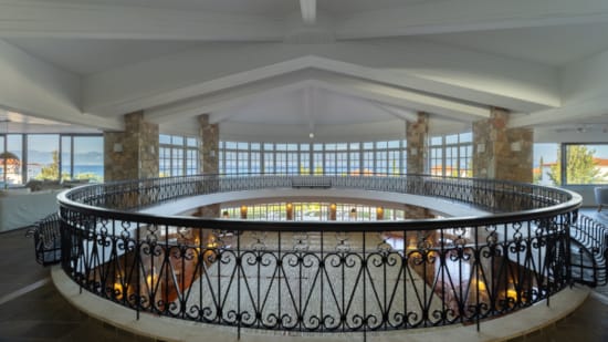 a large room with a large glass railing and a large window