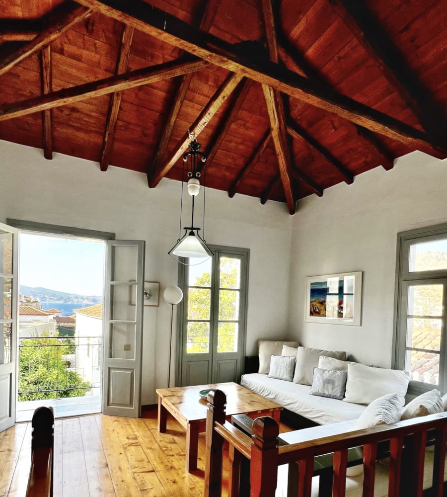 a room with a bed and a table with a lamp on it