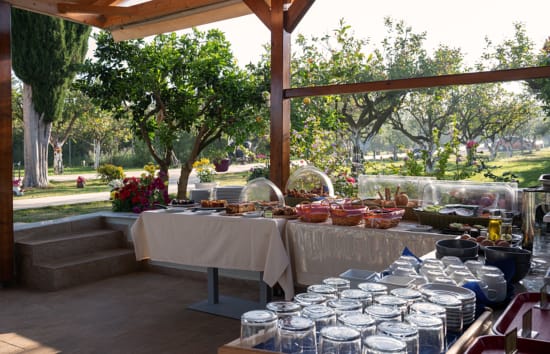 a set of tables with glasses and plates on them