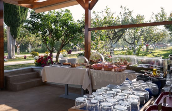 a set of tables with glasses and plates on them