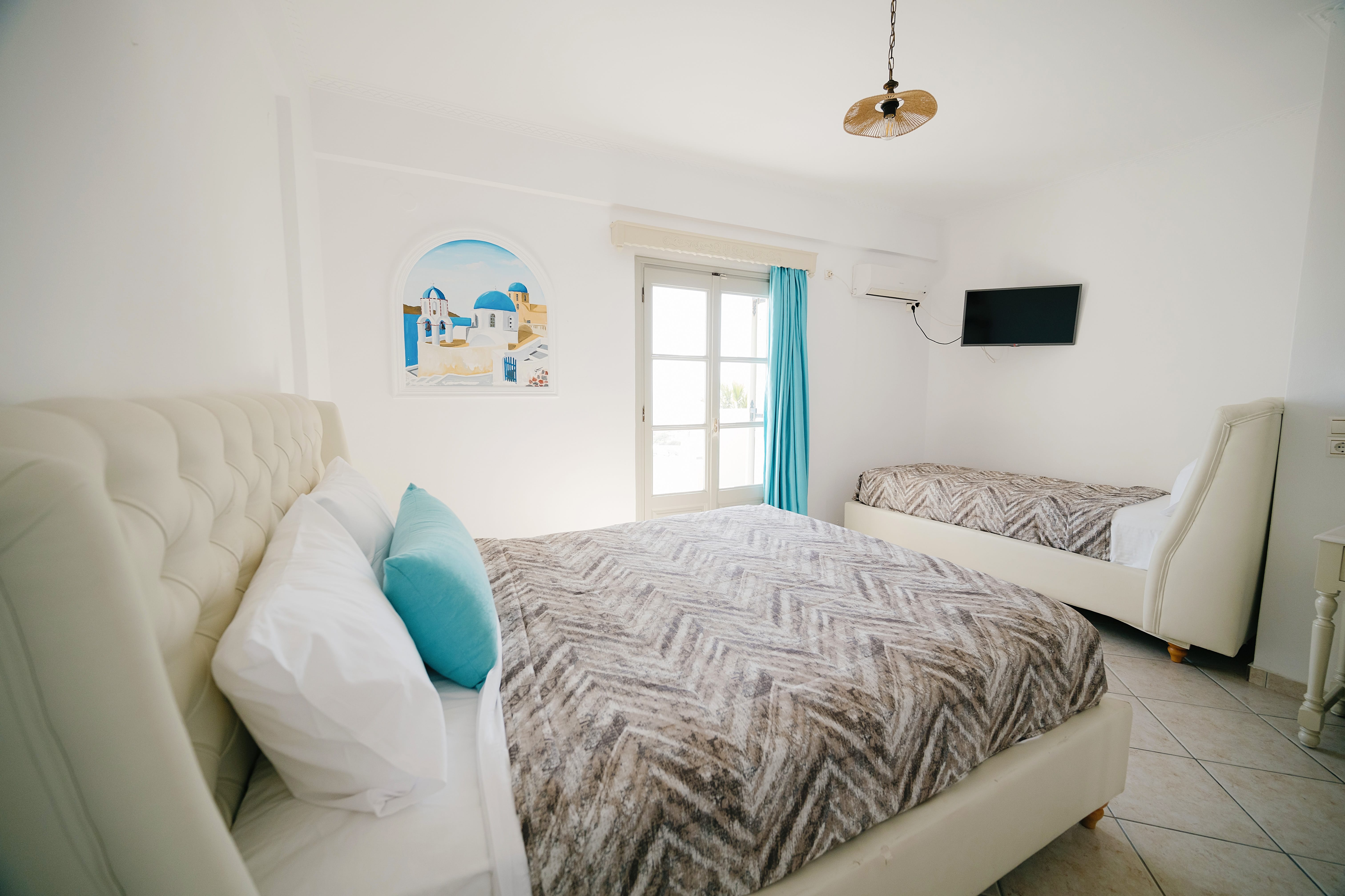 a room with white couches and a painting on the wall