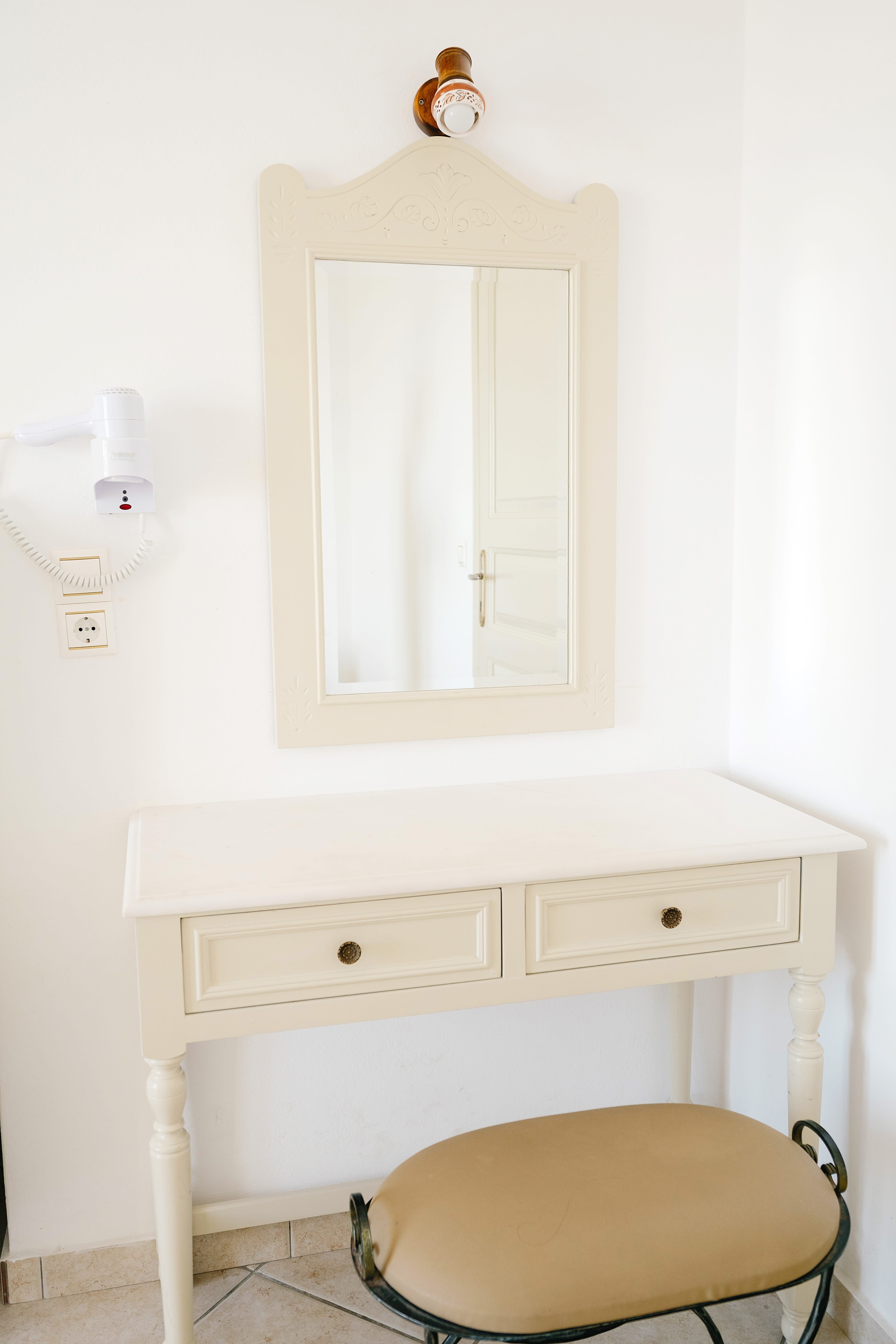a white cabinet with a mirror