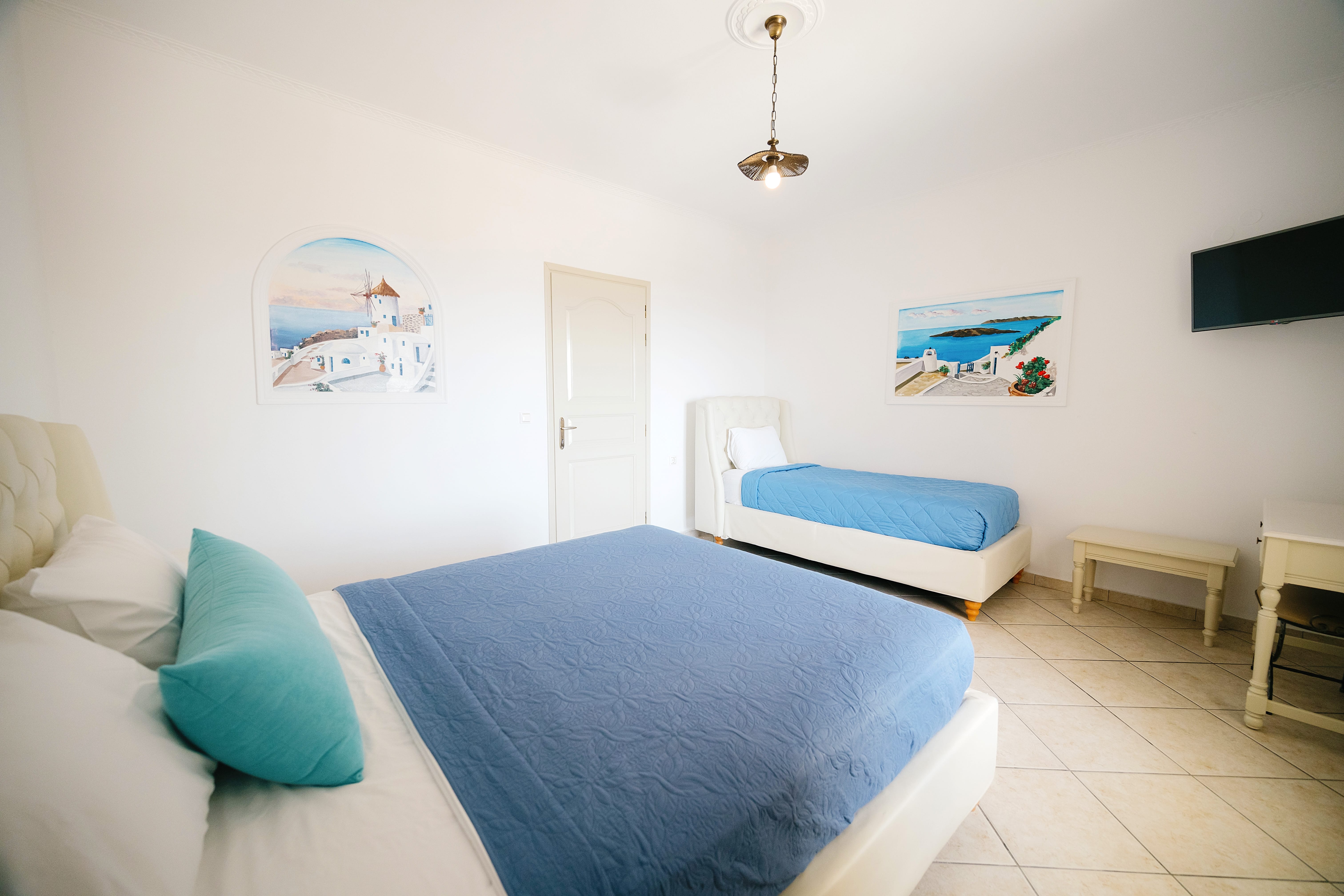 a room with couches and a painting on the wall