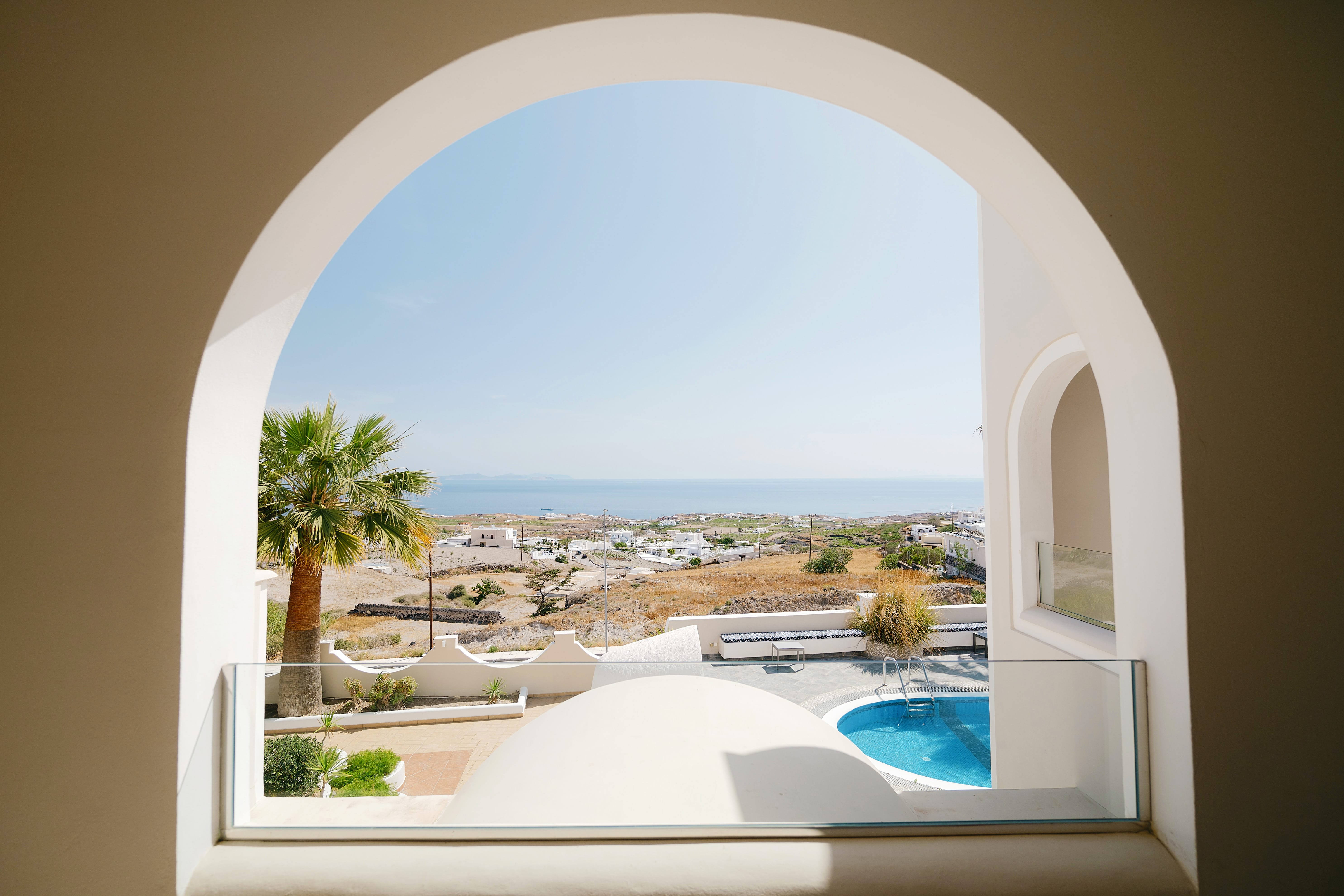 a view of a pool and a city from a window