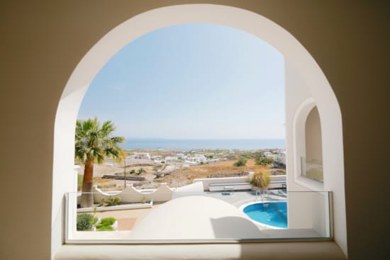 a view of a pool and a city from a window