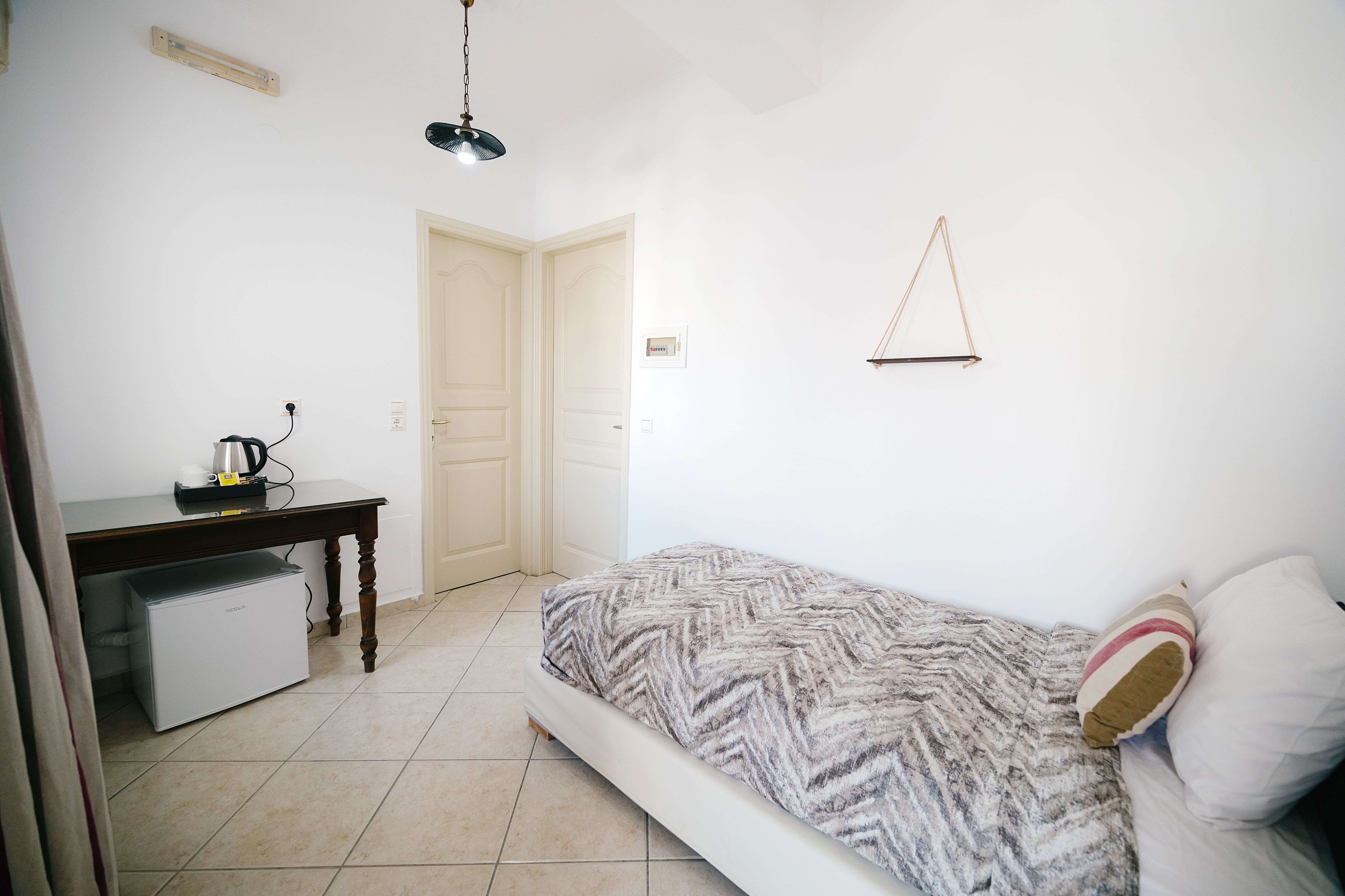 a bedroom with a bed and a desk