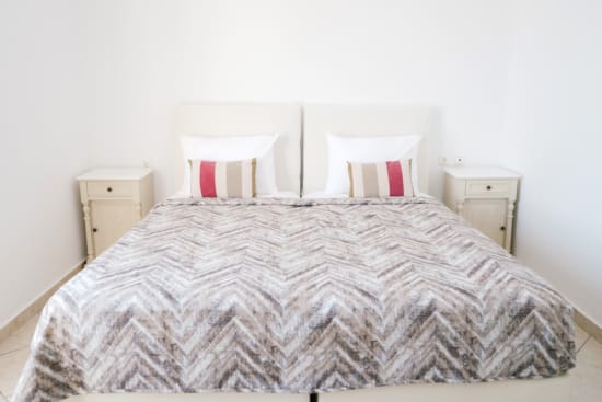 a bed with a white bed spread