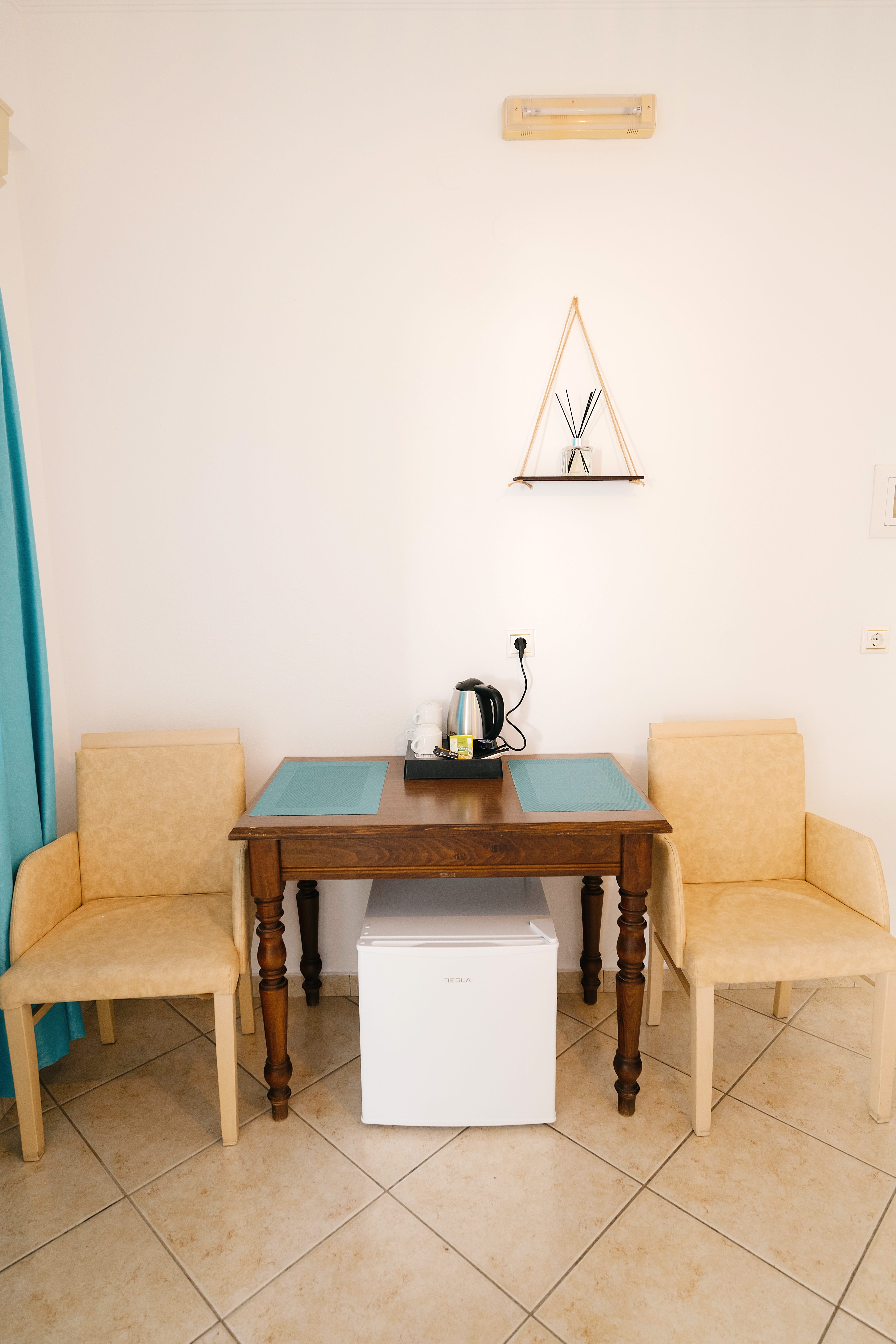 a desk with chairs and a painting on it