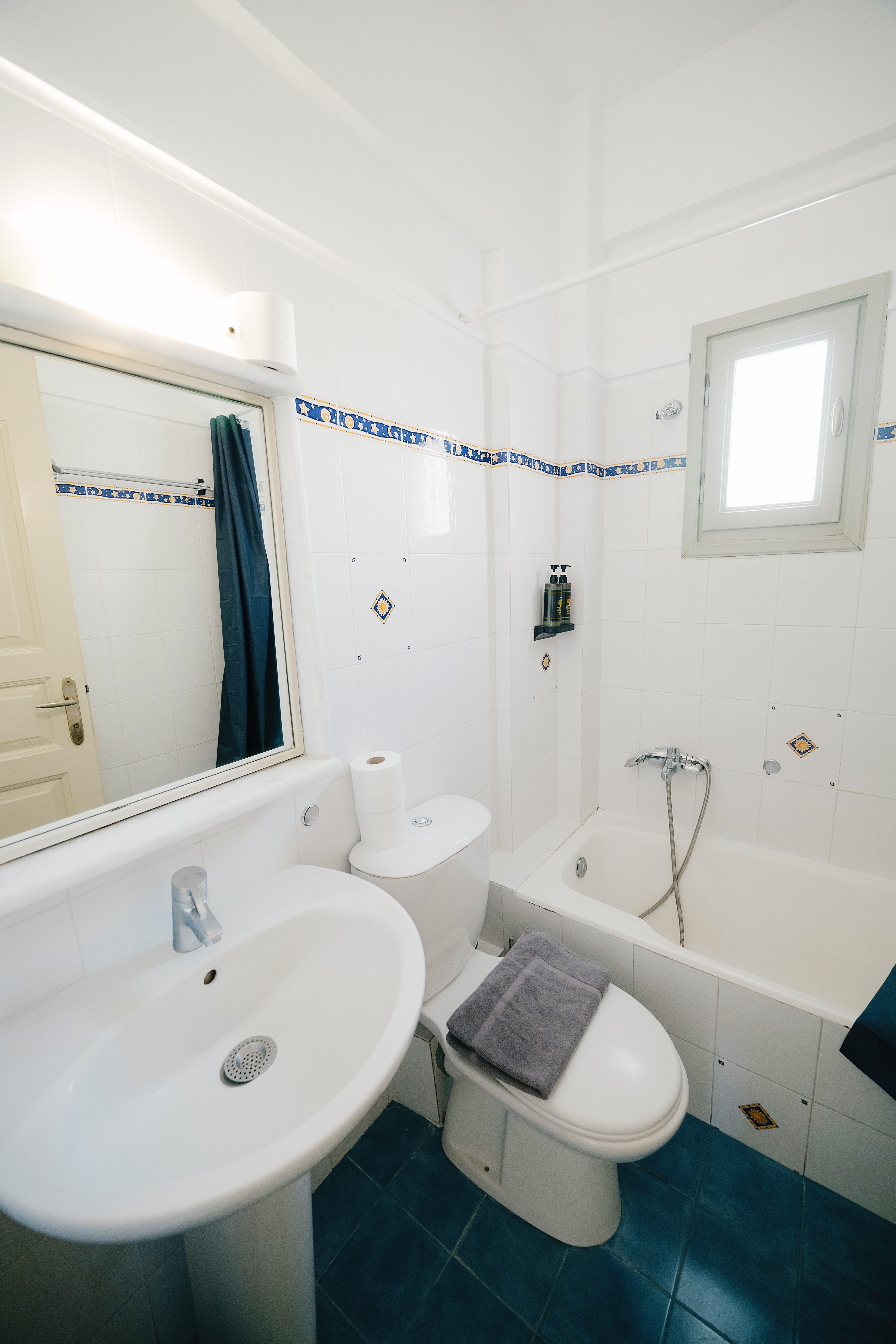 a bathroom with a tub sink and toilet