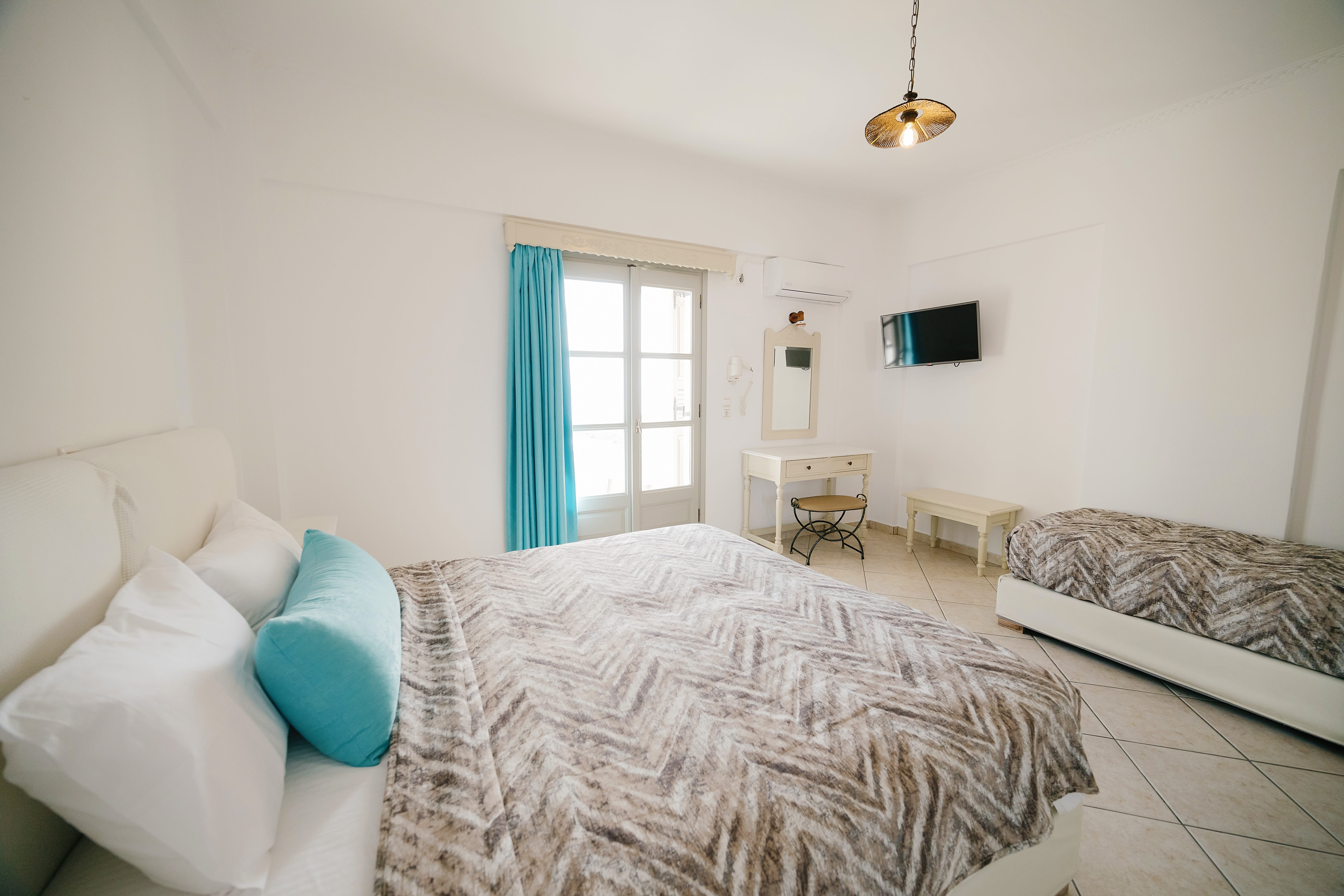 a room with a bed and a television