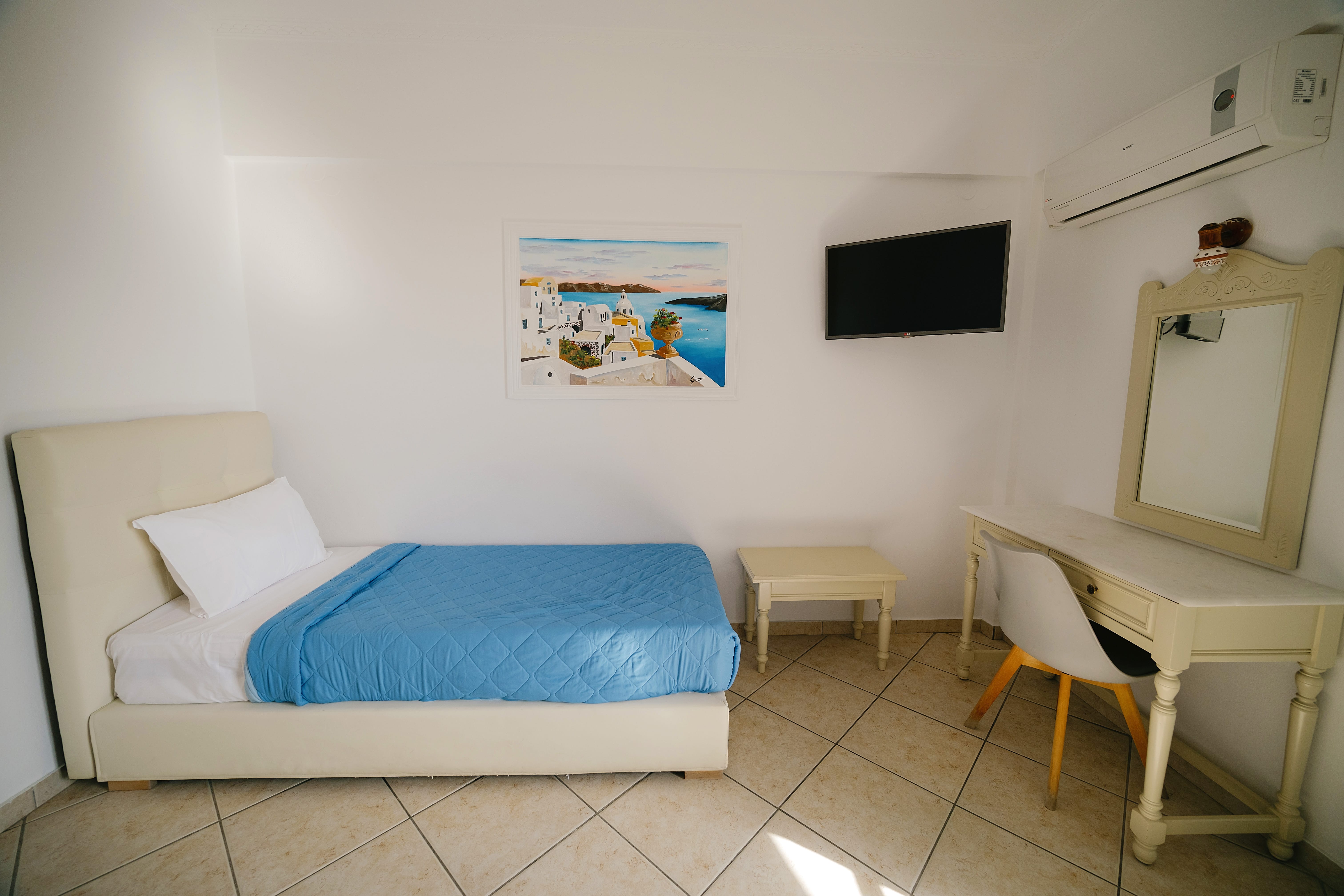 a room with a bed and a tv