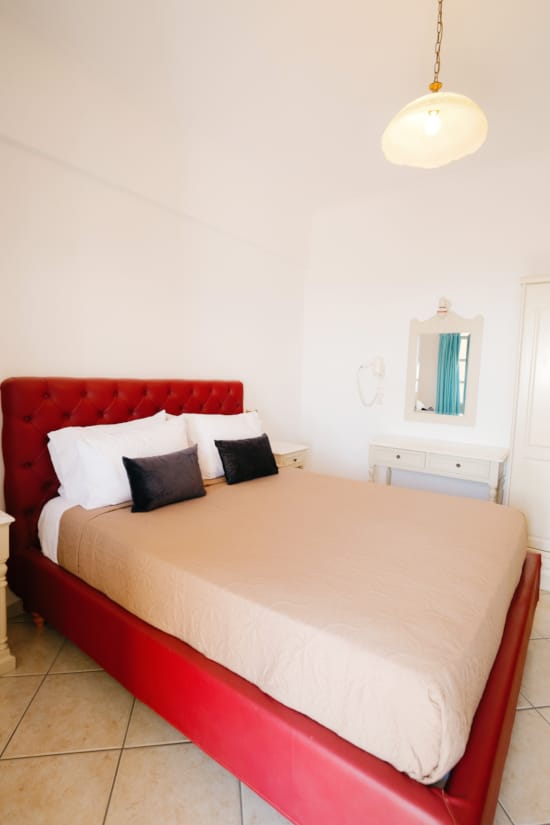 a bed with a red blanket