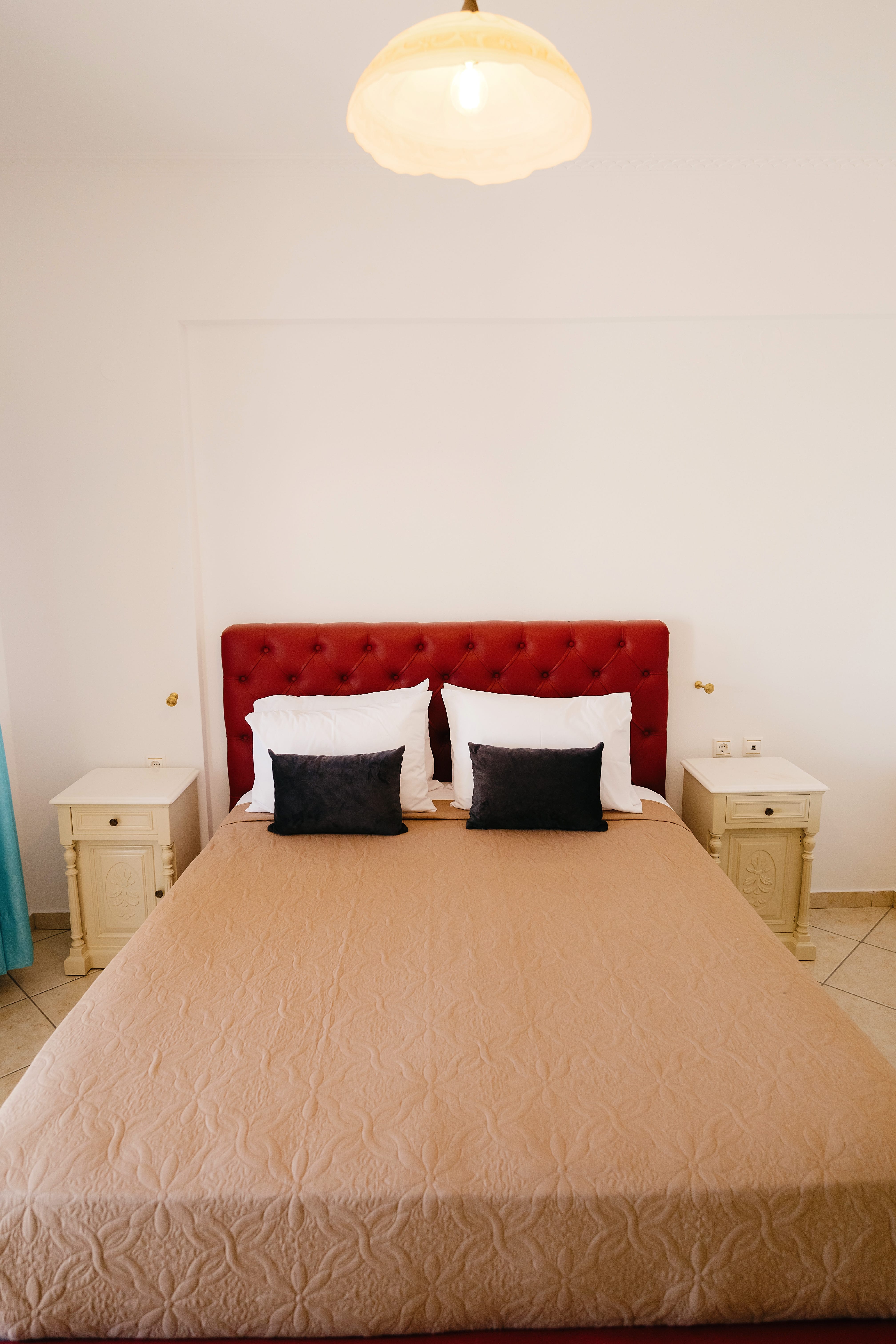 a bed with a red headboard