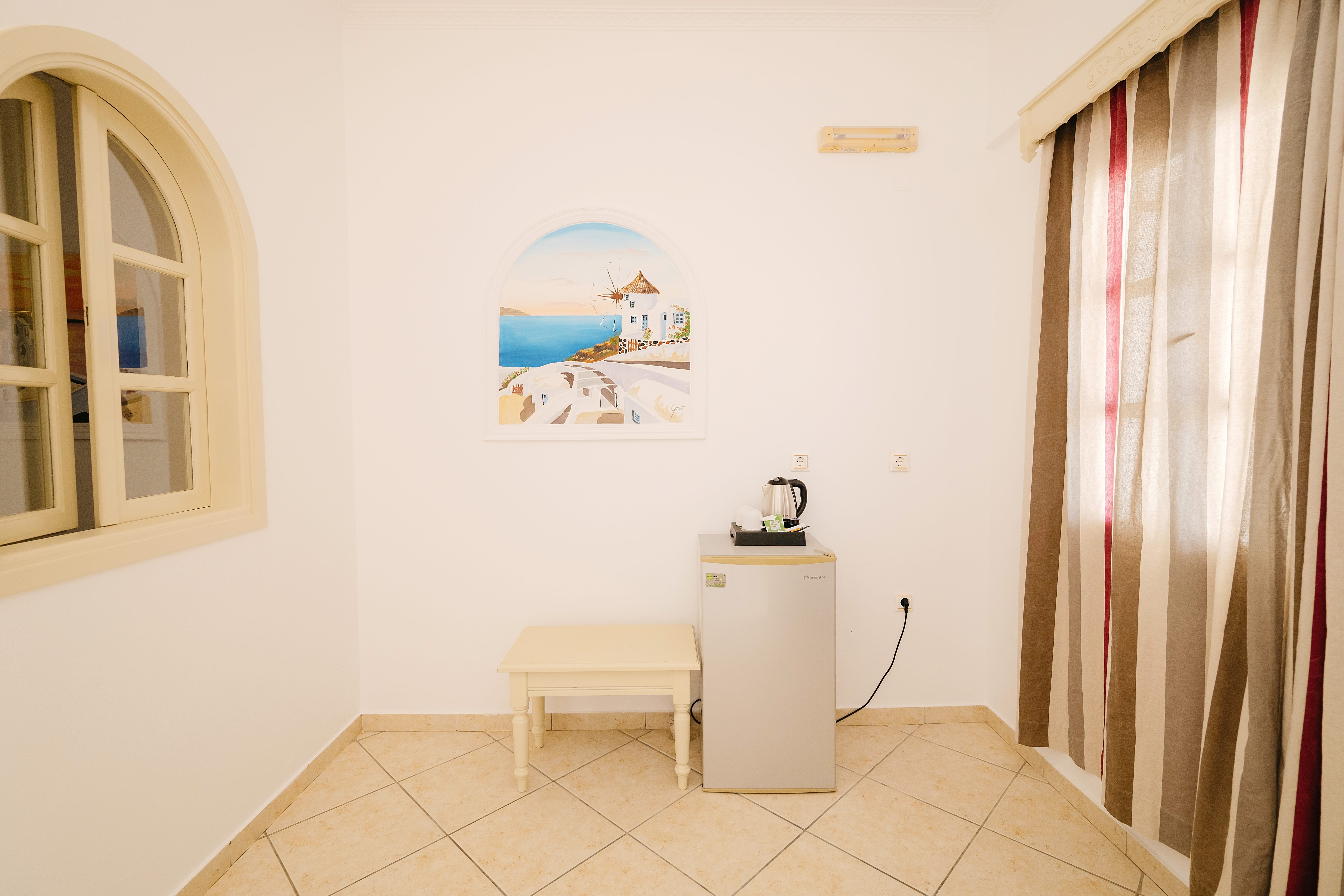 a room with a white wall and a white table with a white chair