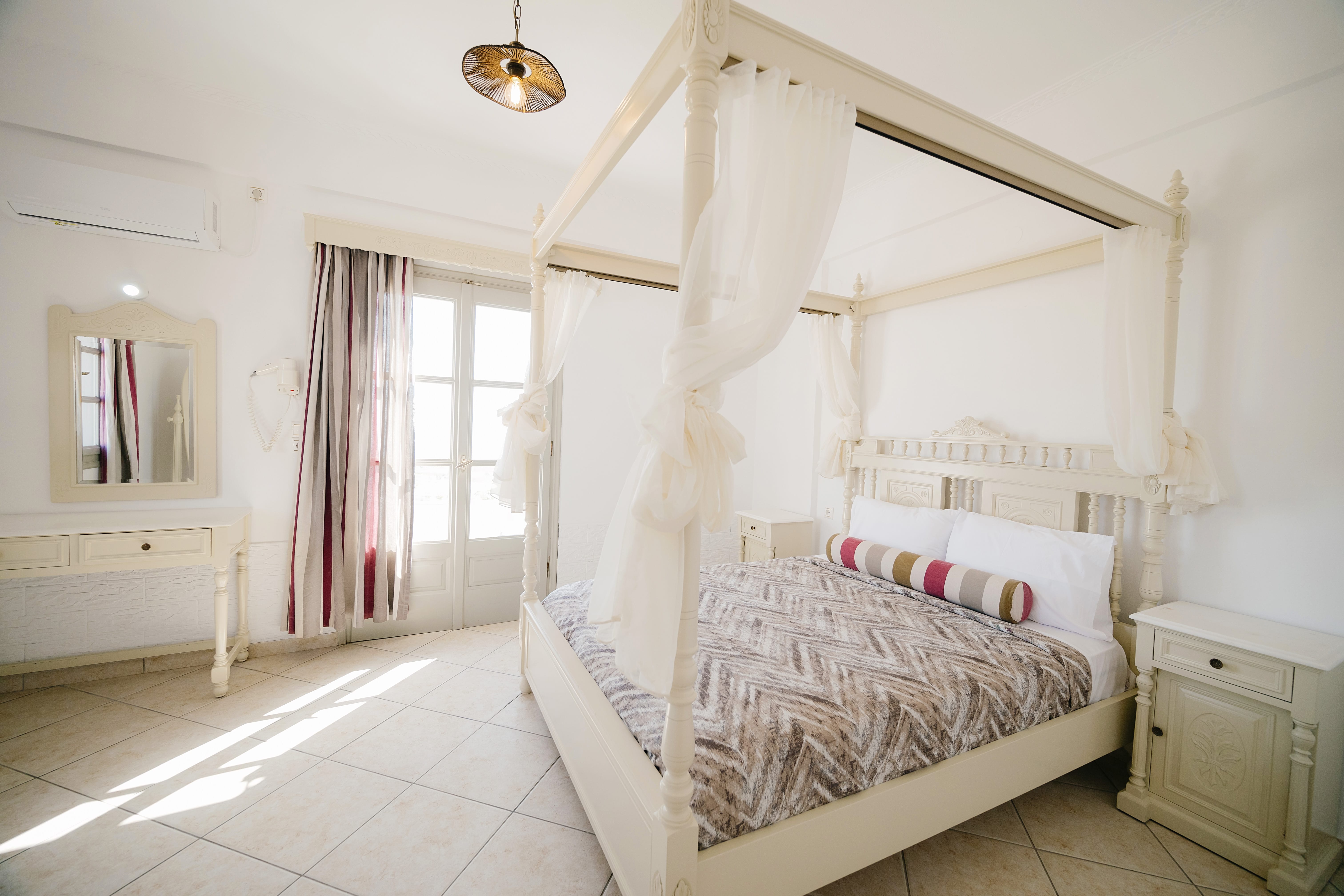 a bedroom with a bed and a canopy