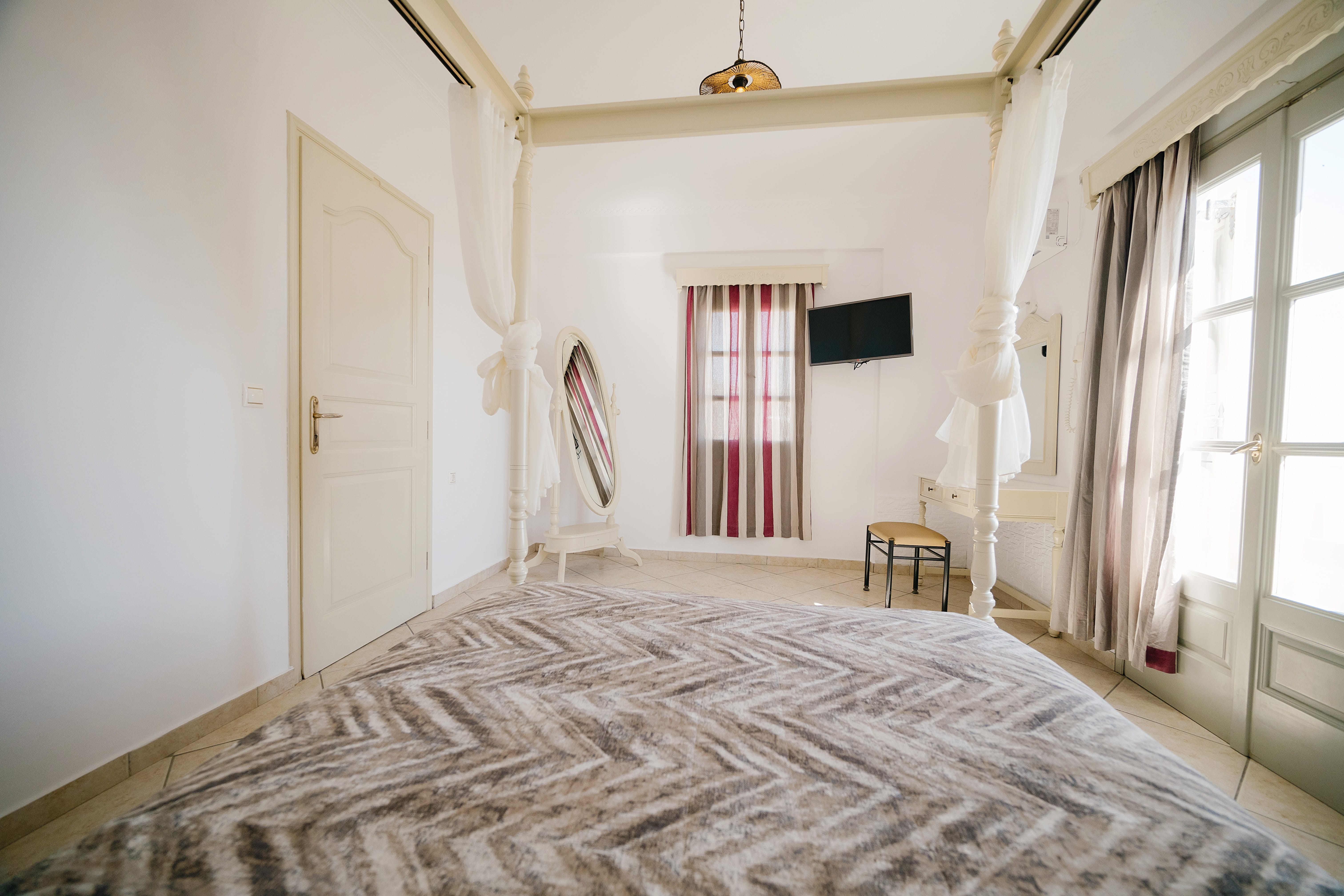 a bedroom with a bed and a television