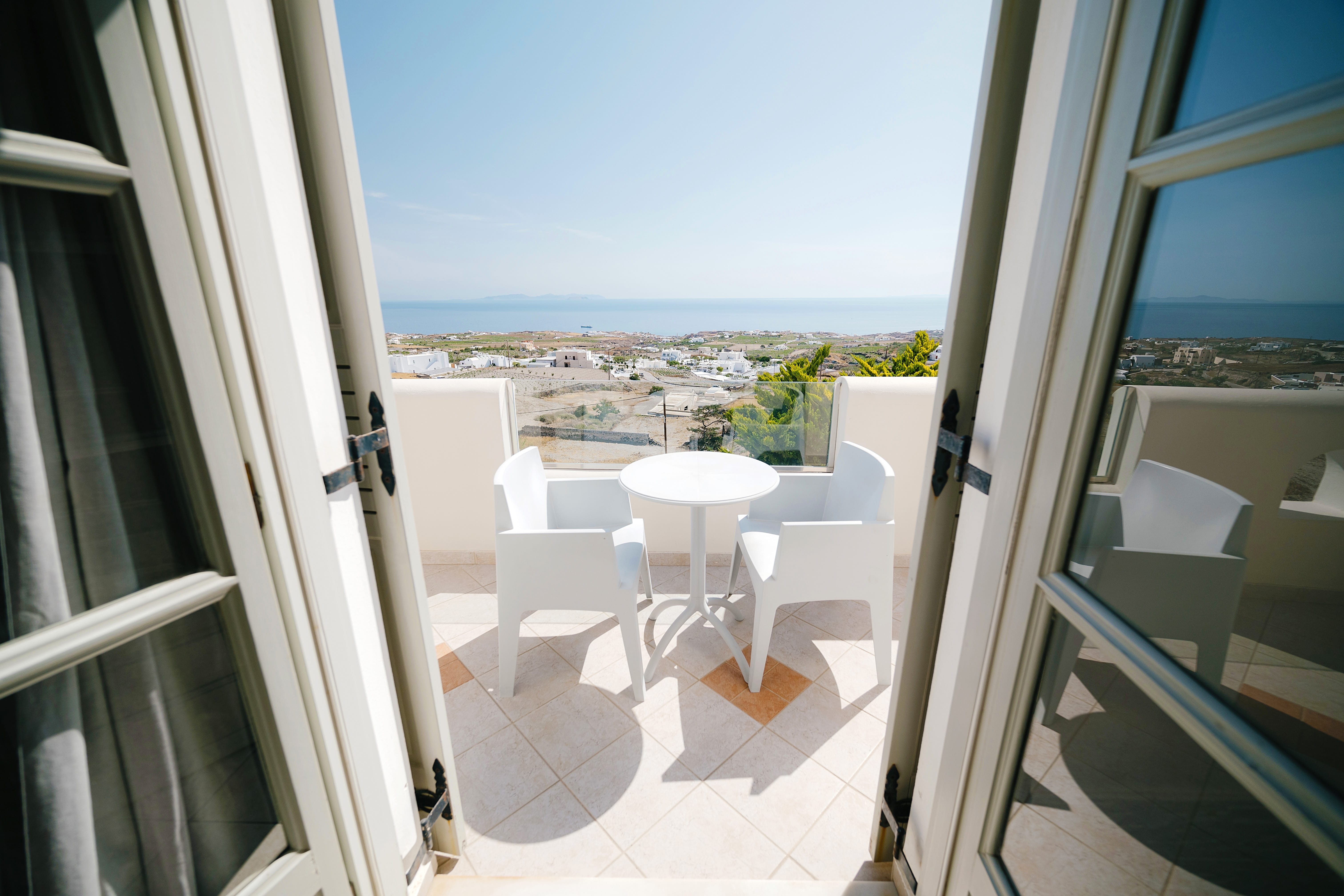 a balcony with a view of the ocean and the city