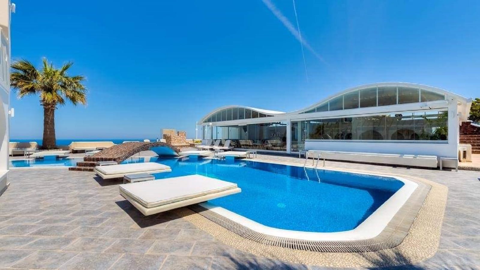 a swimming pool with a building in the background