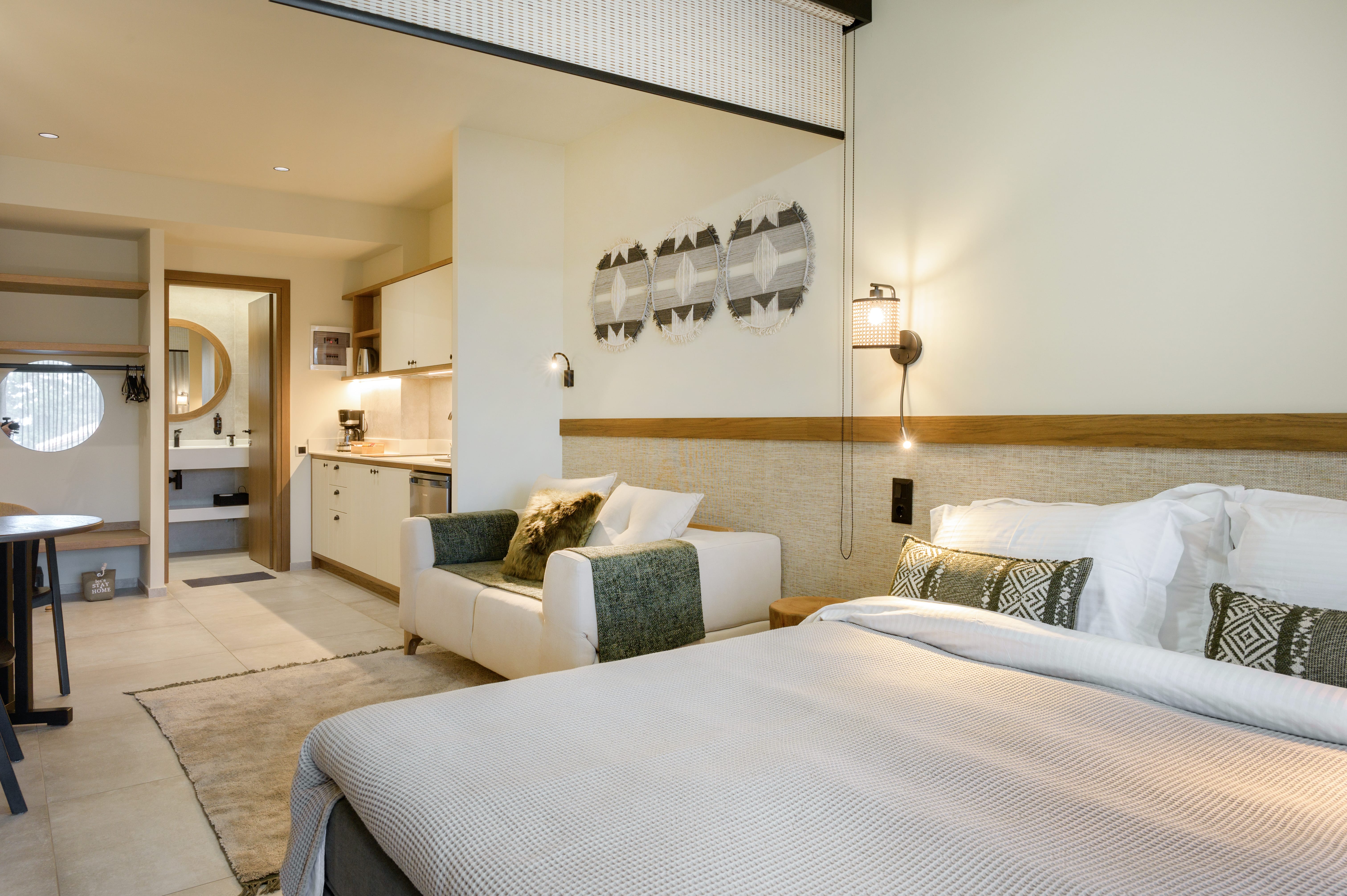 a hotel room with a bed and couches