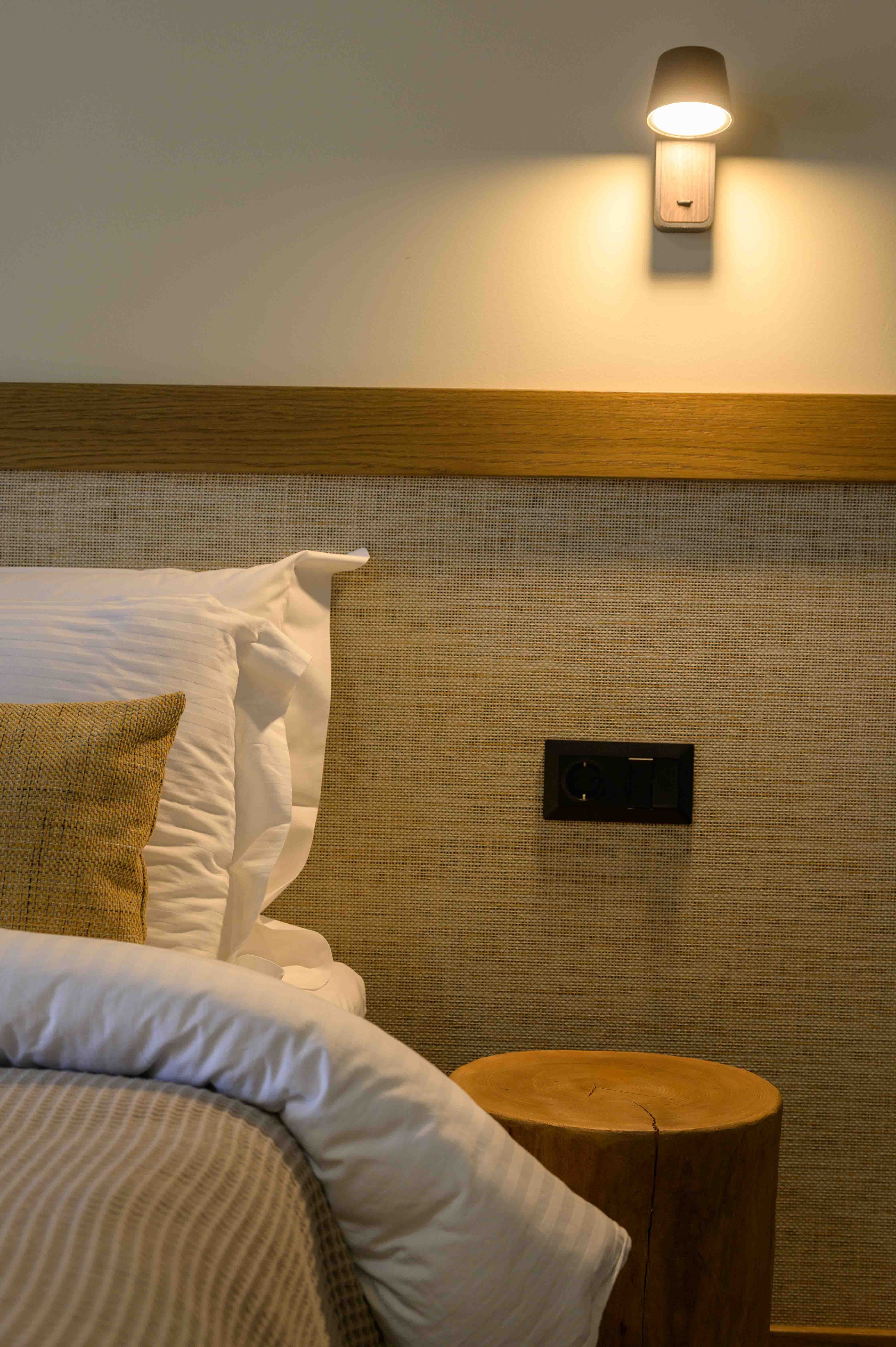 a bed with a table and a lamp