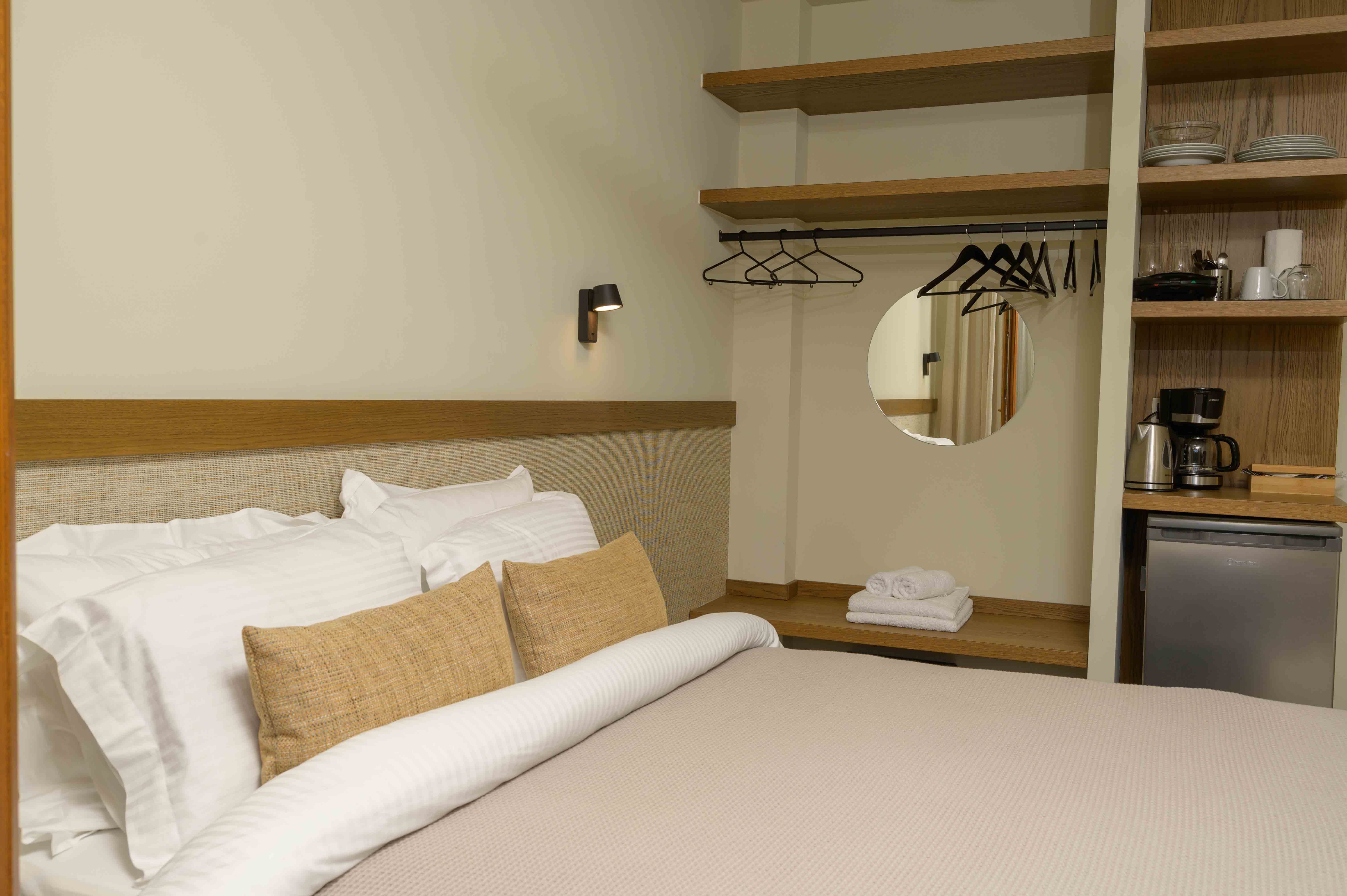 a bed with a mirror above it