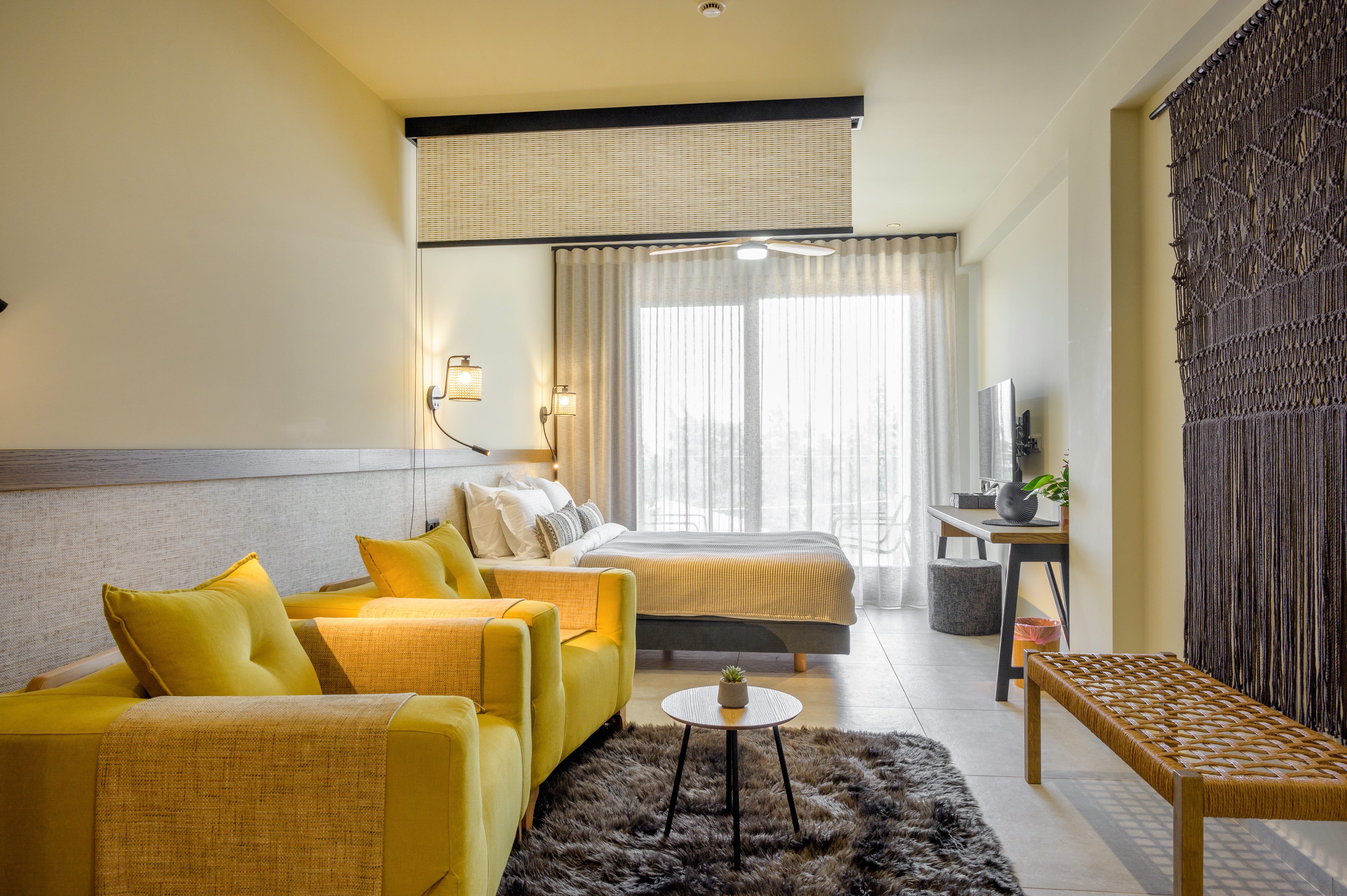 a living room with yellow couches