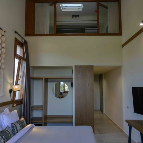 a room with a tv and a bed