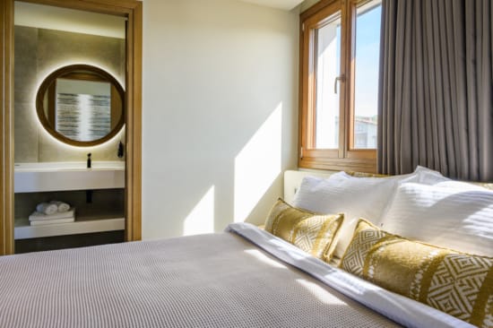 a bed with a mirror above it