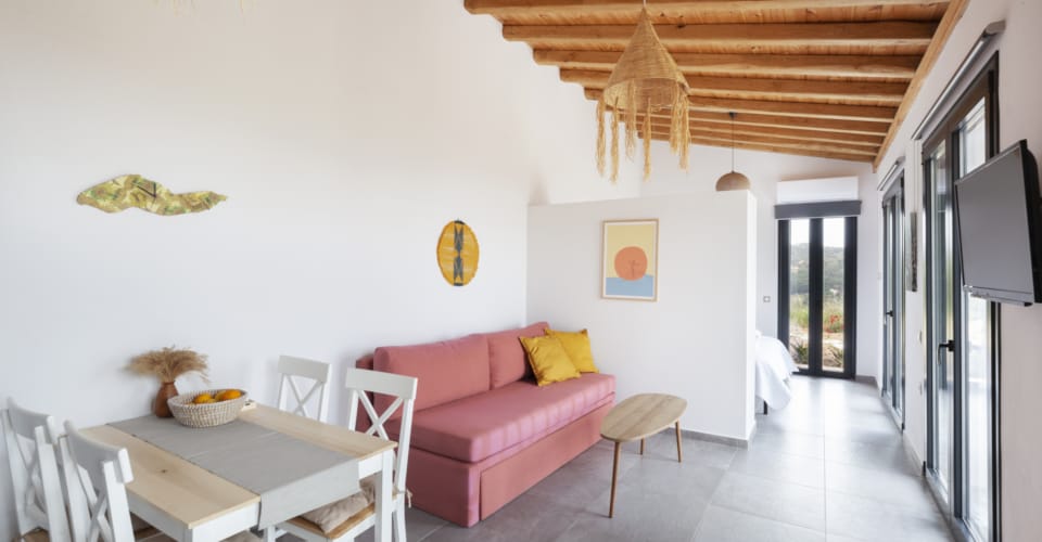 a living room with a red couch and a table