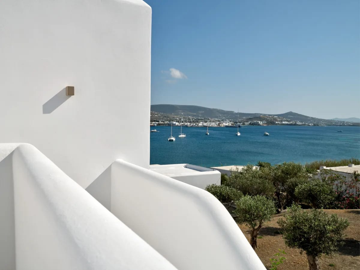 a white building with a body of water in the background