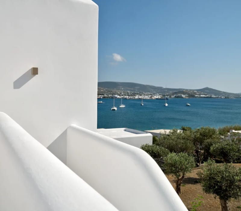 a white building with a body of water in the background