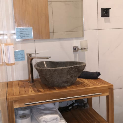 a wooden shelf with a bowl and a bowl on it