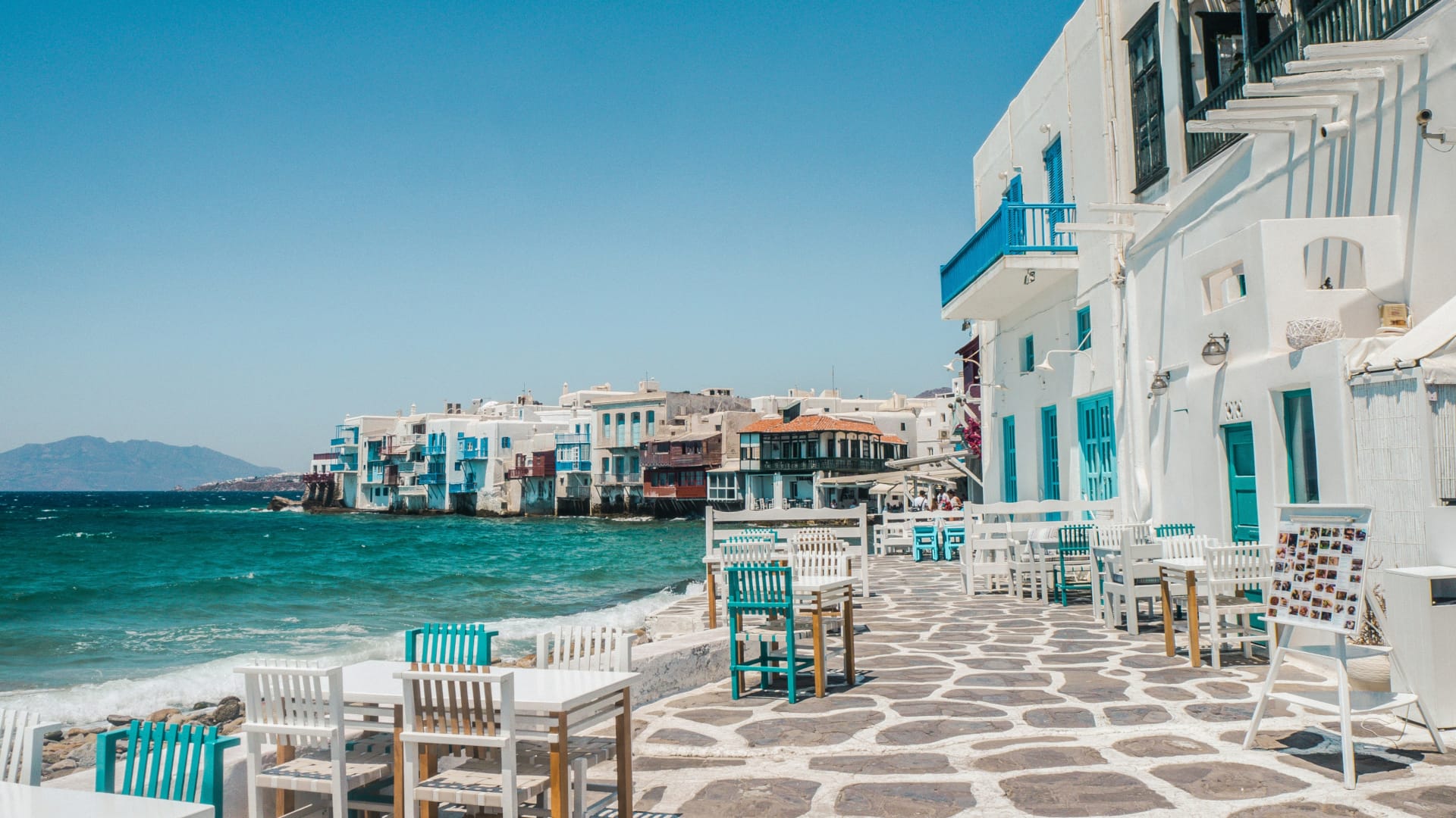 a row of buildings next to a body of water