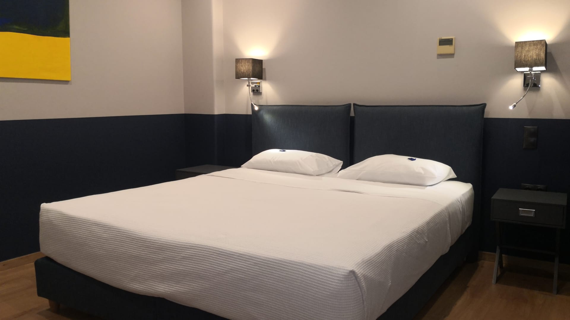 a bed with a blue headboard