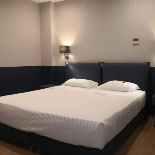 a bed with a blue headboard