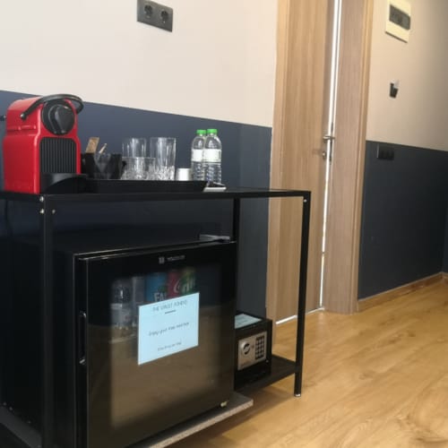 a black machine with a red and white box on top