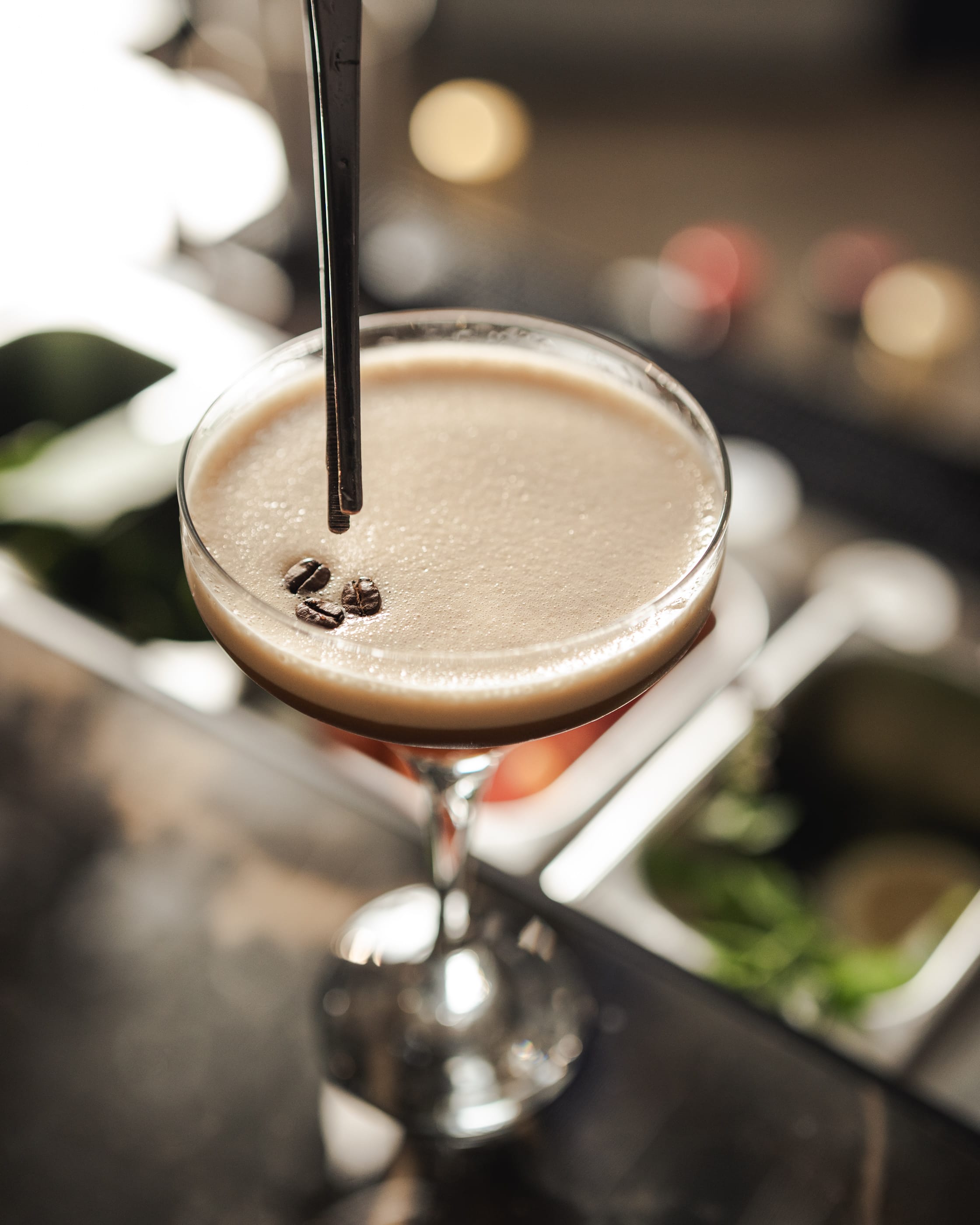 a glass of liquid with a spoon