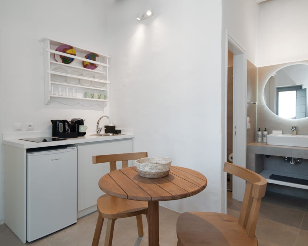 a small kitchen with a table and chairs
