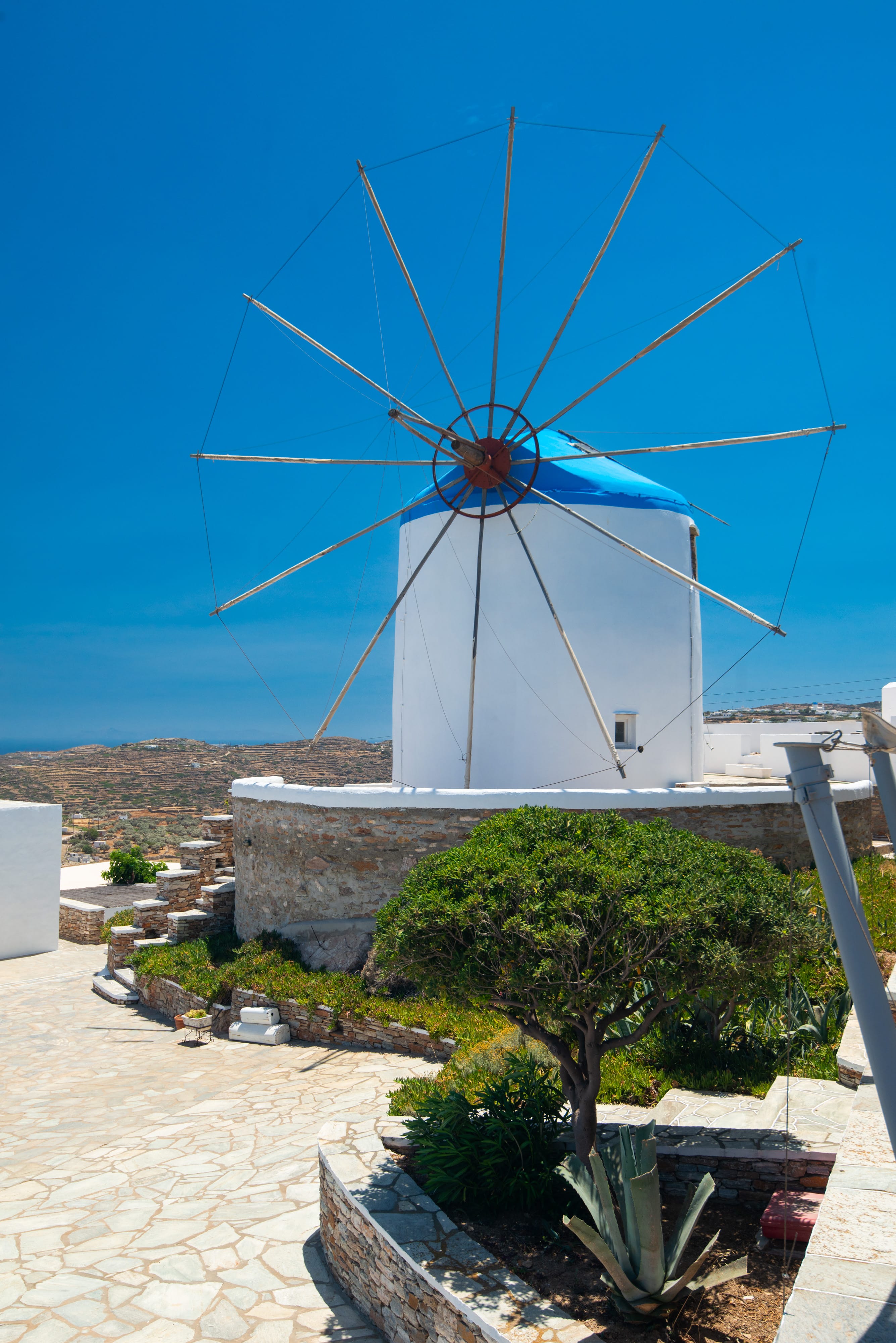 a white windmill with a blue sky