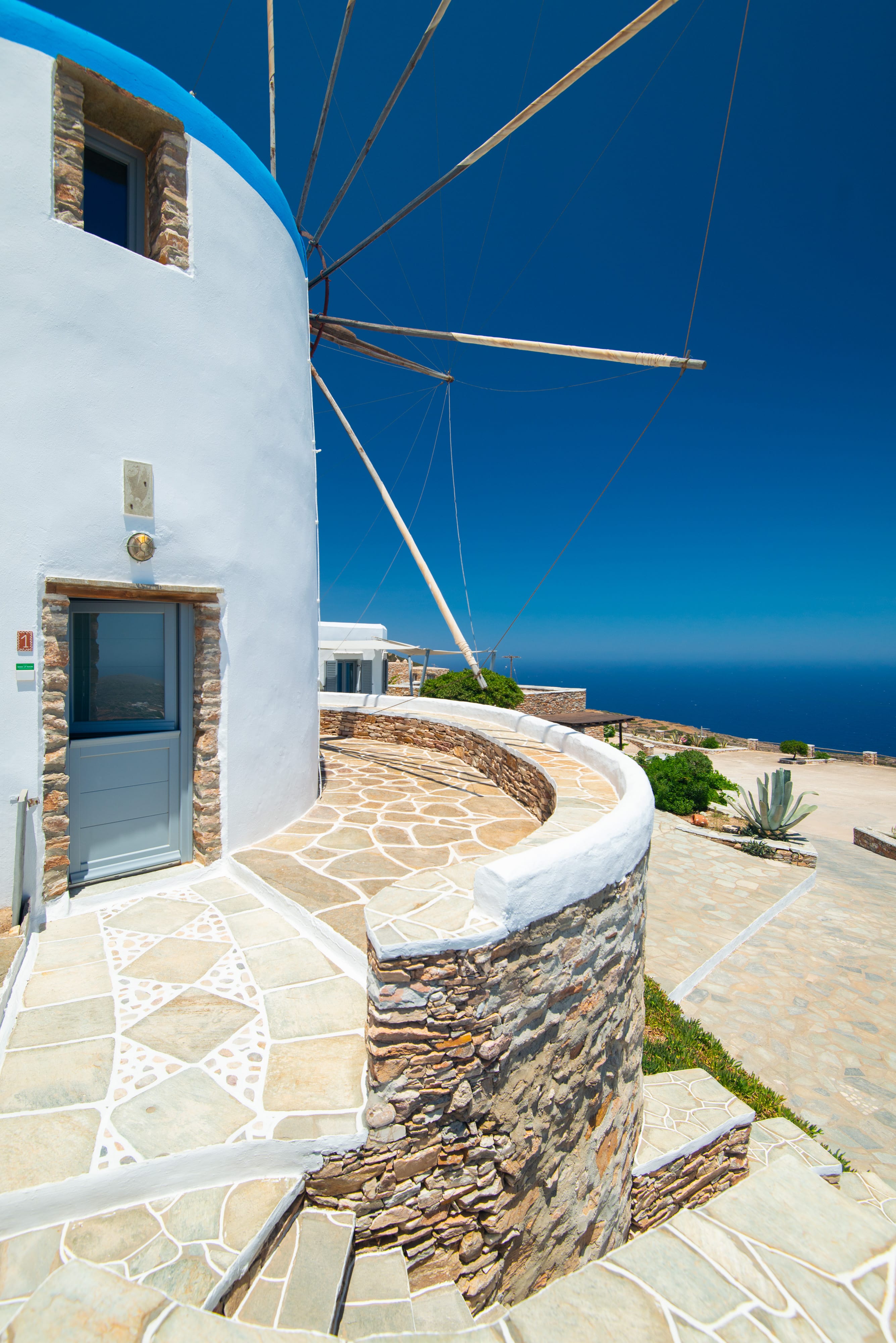 a white building with a stone patio