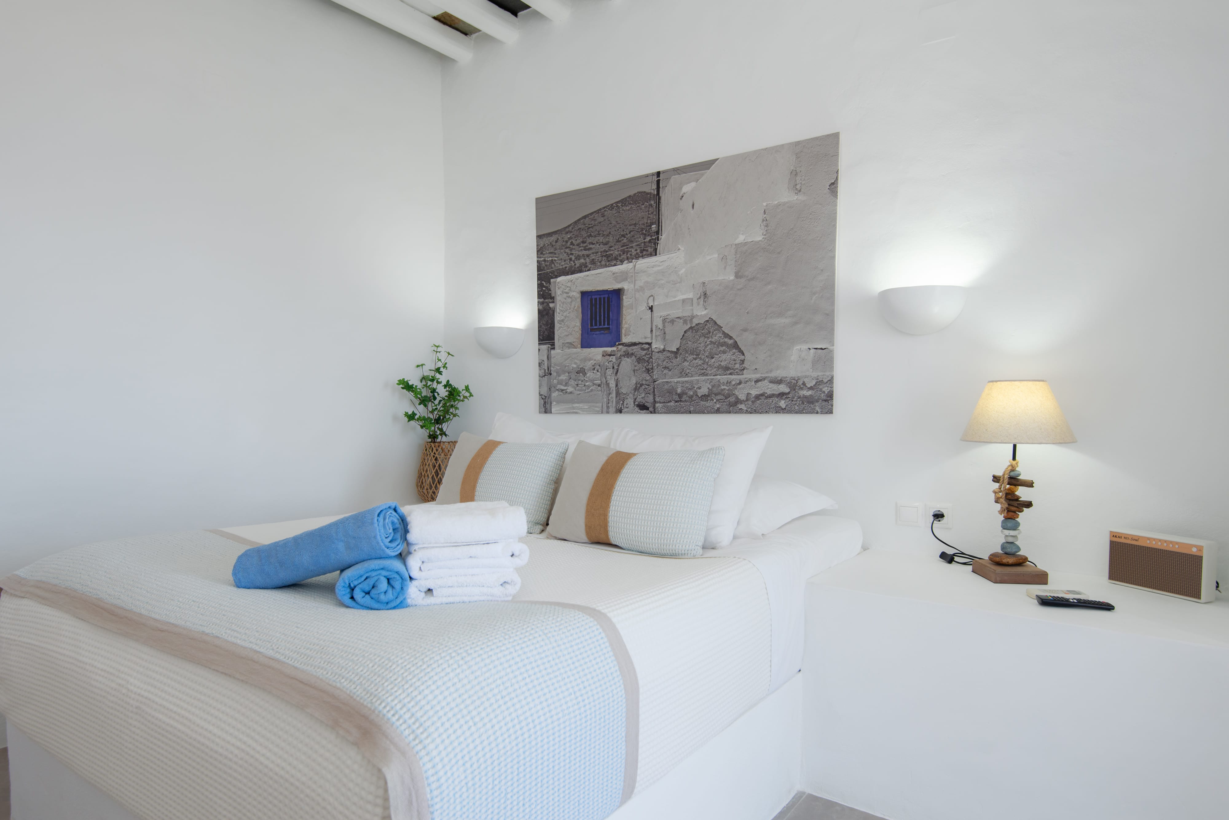 a bed with a painting on the wall