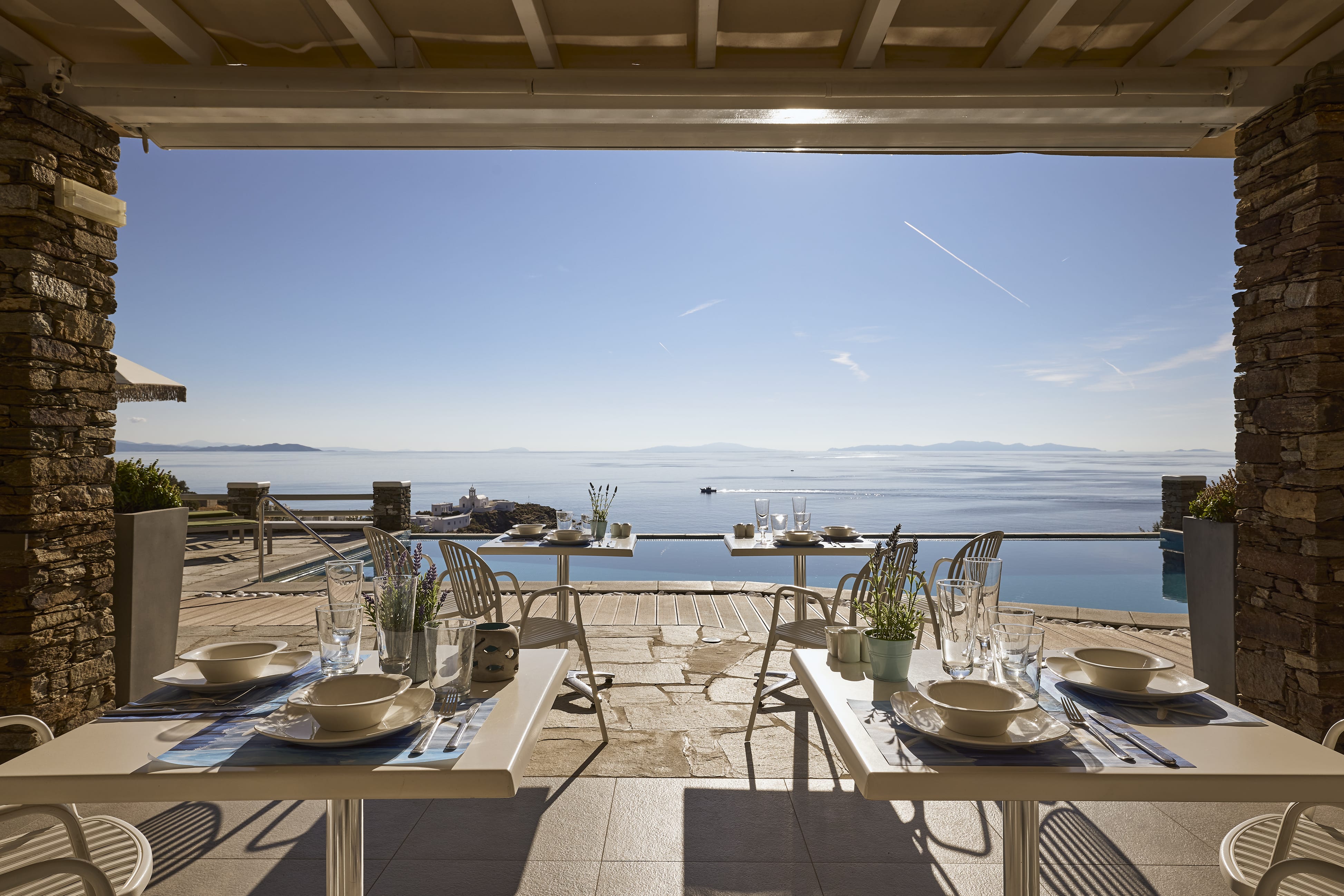 a table with plates and bowls on it by a body of water