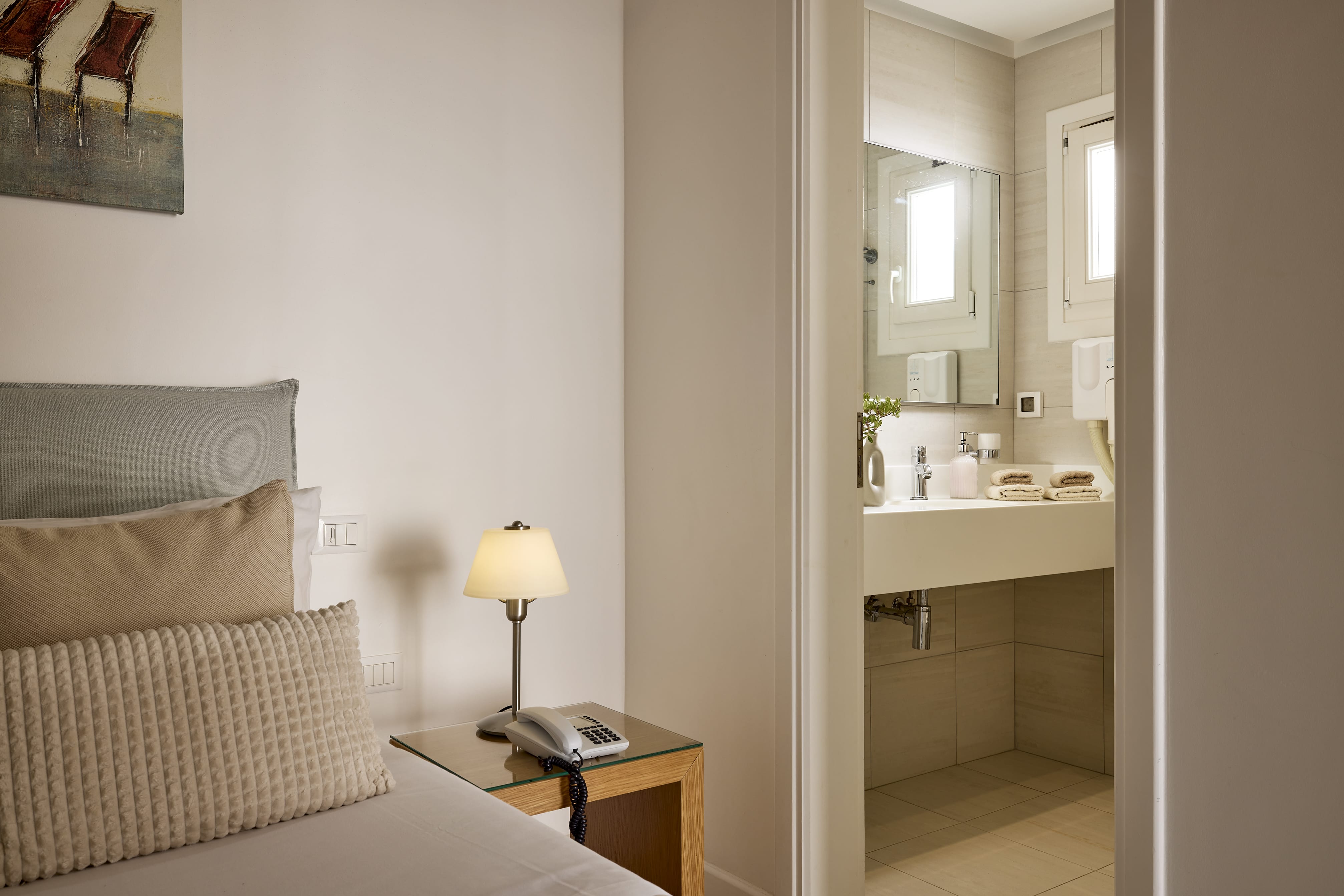 a hotel room with a bed and a desk