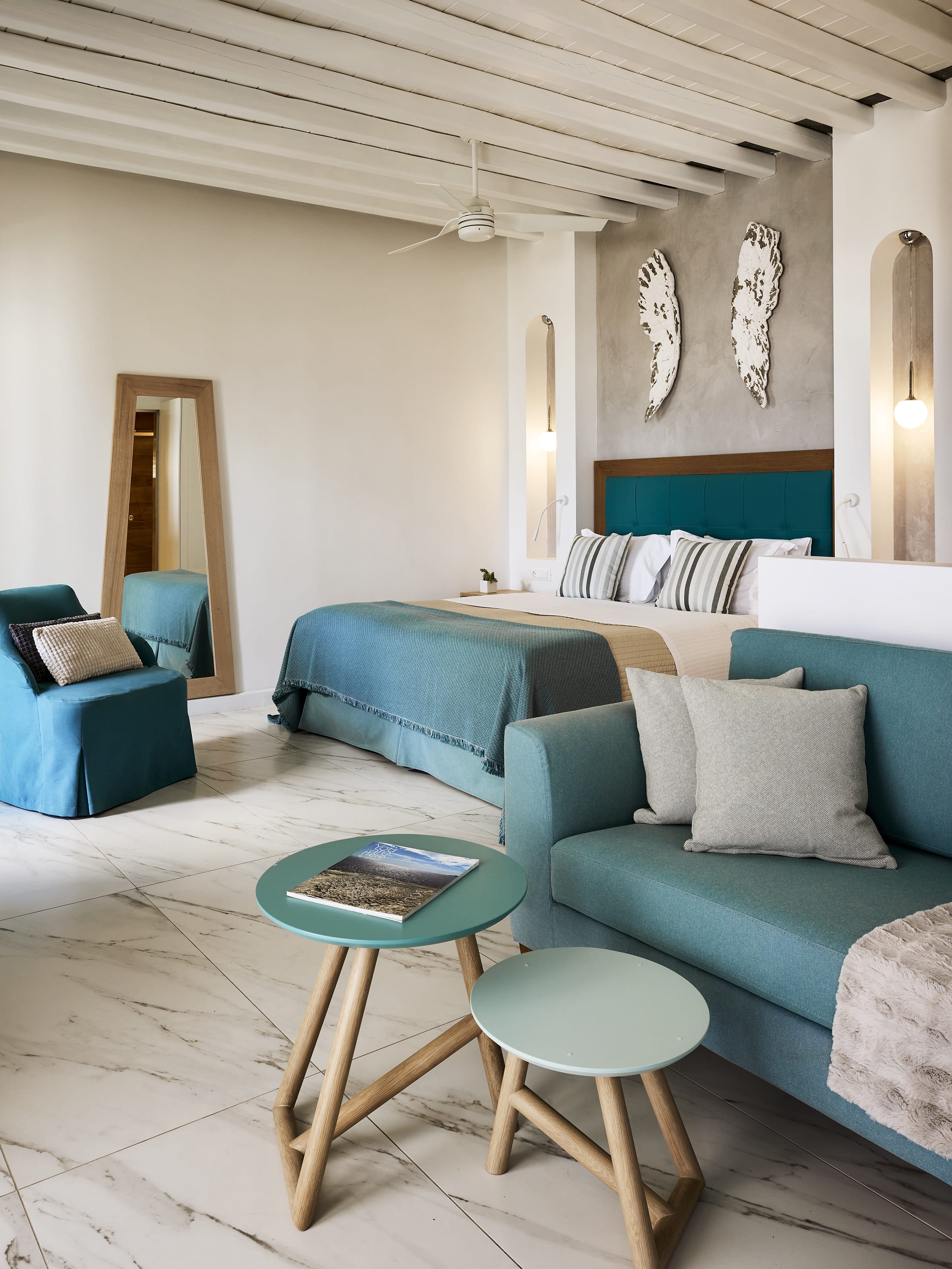 a room with blue couches and a table